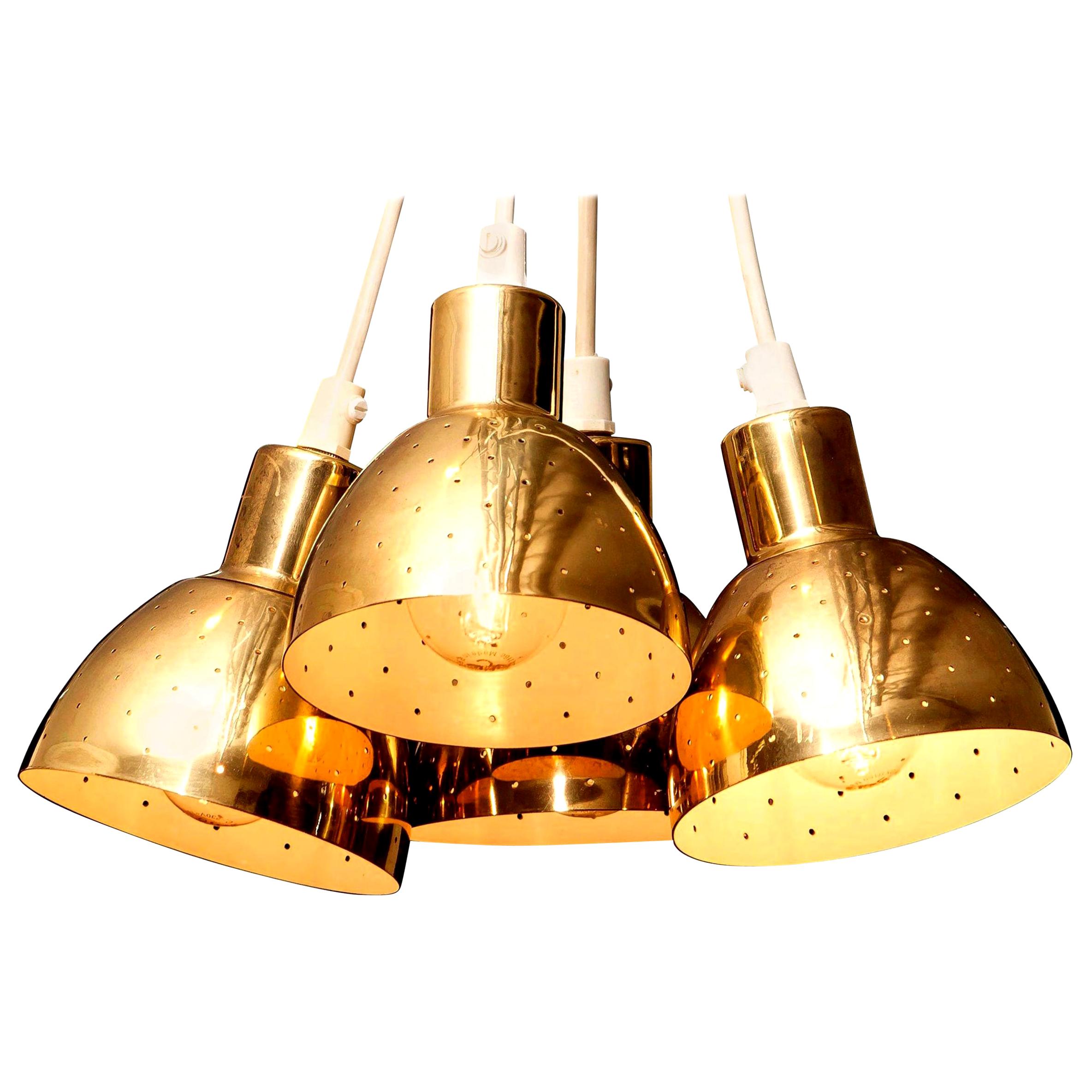 Great set of four brass pendants by Hans-Agne Jakobsson for Markaryd, Sweden.
Each lamp has perforation with gives the light a beautiful shining.
They are in a good and working condition.
Period: 1960s.
Dimensions: H 11 cm, Ø 11 cm.