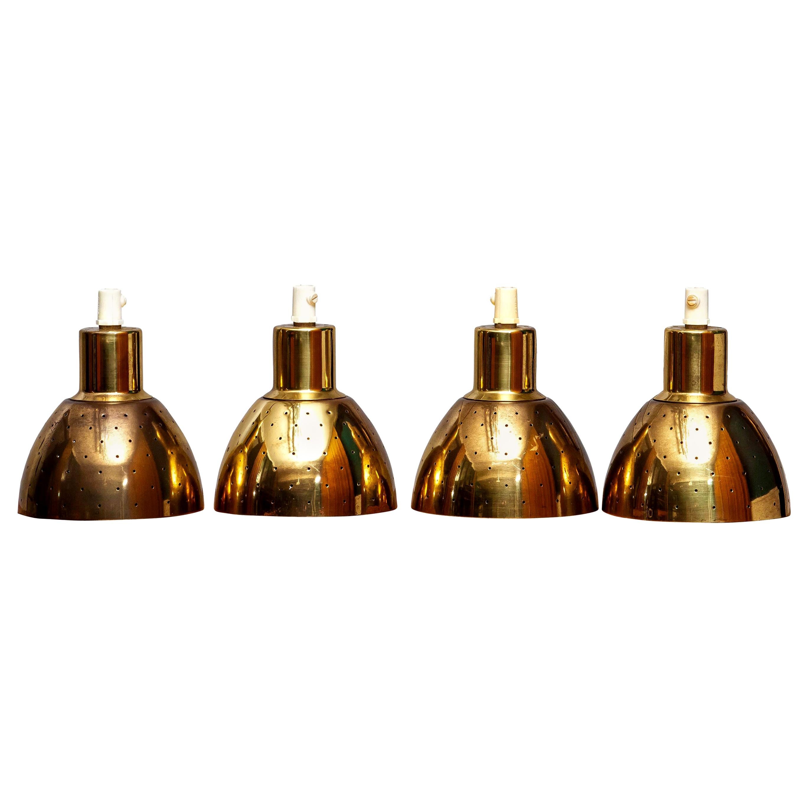 Great set of four brass pendants by Hans-Agne Jakobsson for Markaryd, Sweden.
Each lamp has perforation with gives the light a beautiful shining.
They are in a good and working condition.
Period: 1960s.
Dimensions: H 11 cm, Ø 11 cm.