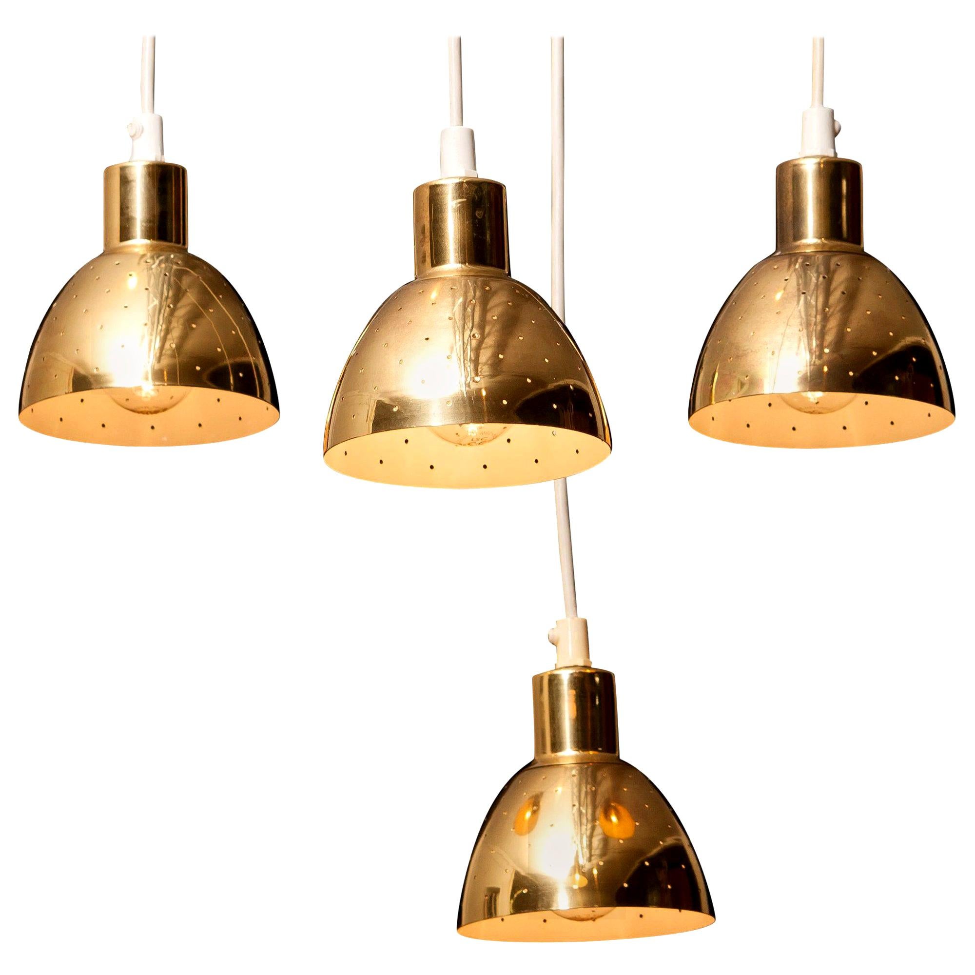 Great set of four brass pendants by Hans-Agne Jakobsson for Markaryd, Sweden.
Each lamp has perforation with gives the light a beautiful shining.
They are in a good and working condition.
Period: 1960s.
Dimensions: H 11 cm, Ø 11 cm.