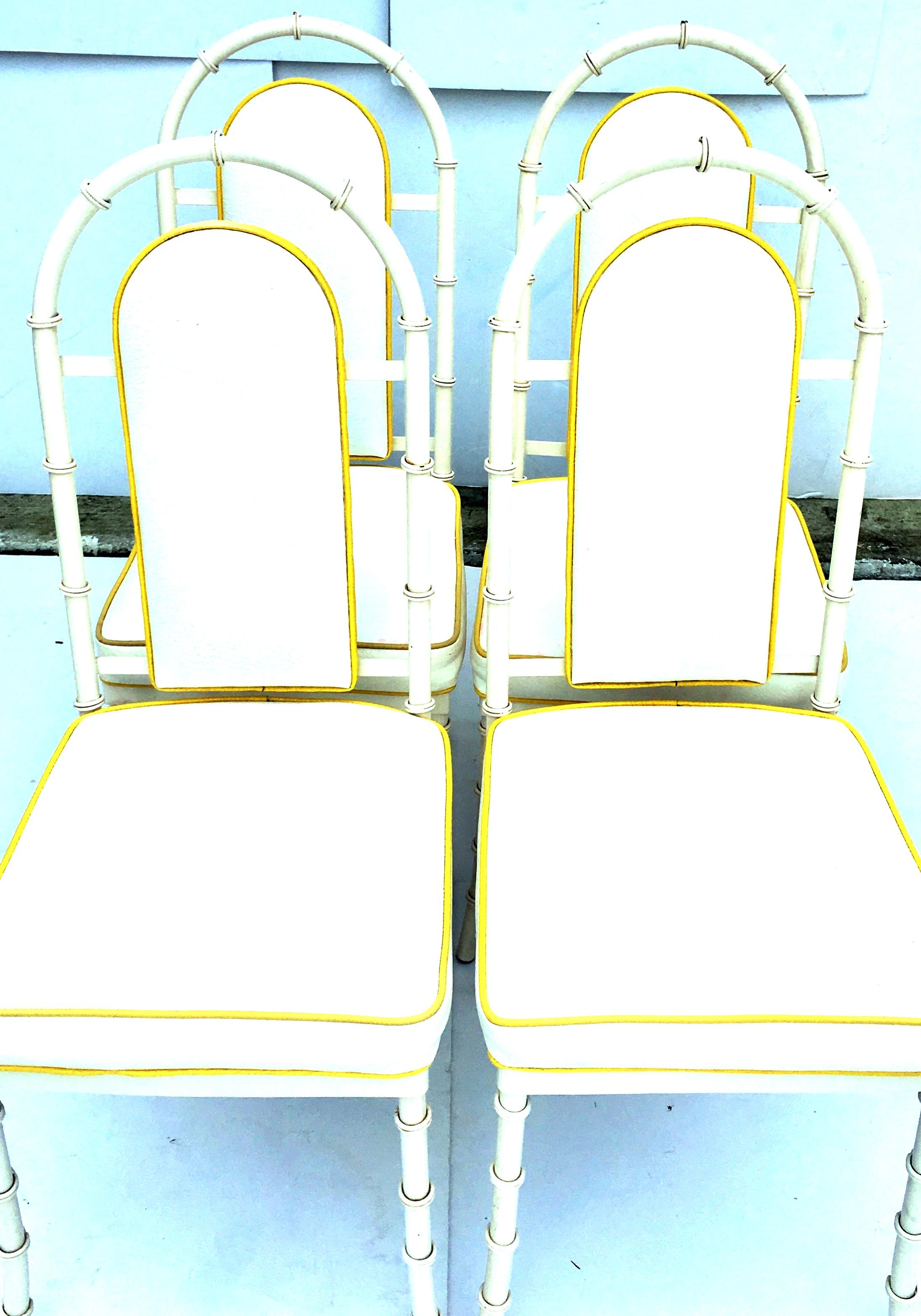 1960s coveted and rare set of four white faux bamboo upholstered high back chairs by, Kessler. Upholstered in the original textured white with yellow piping vinyl seats and backs. The Kessler manufacturing tag is present on some of the chairs.