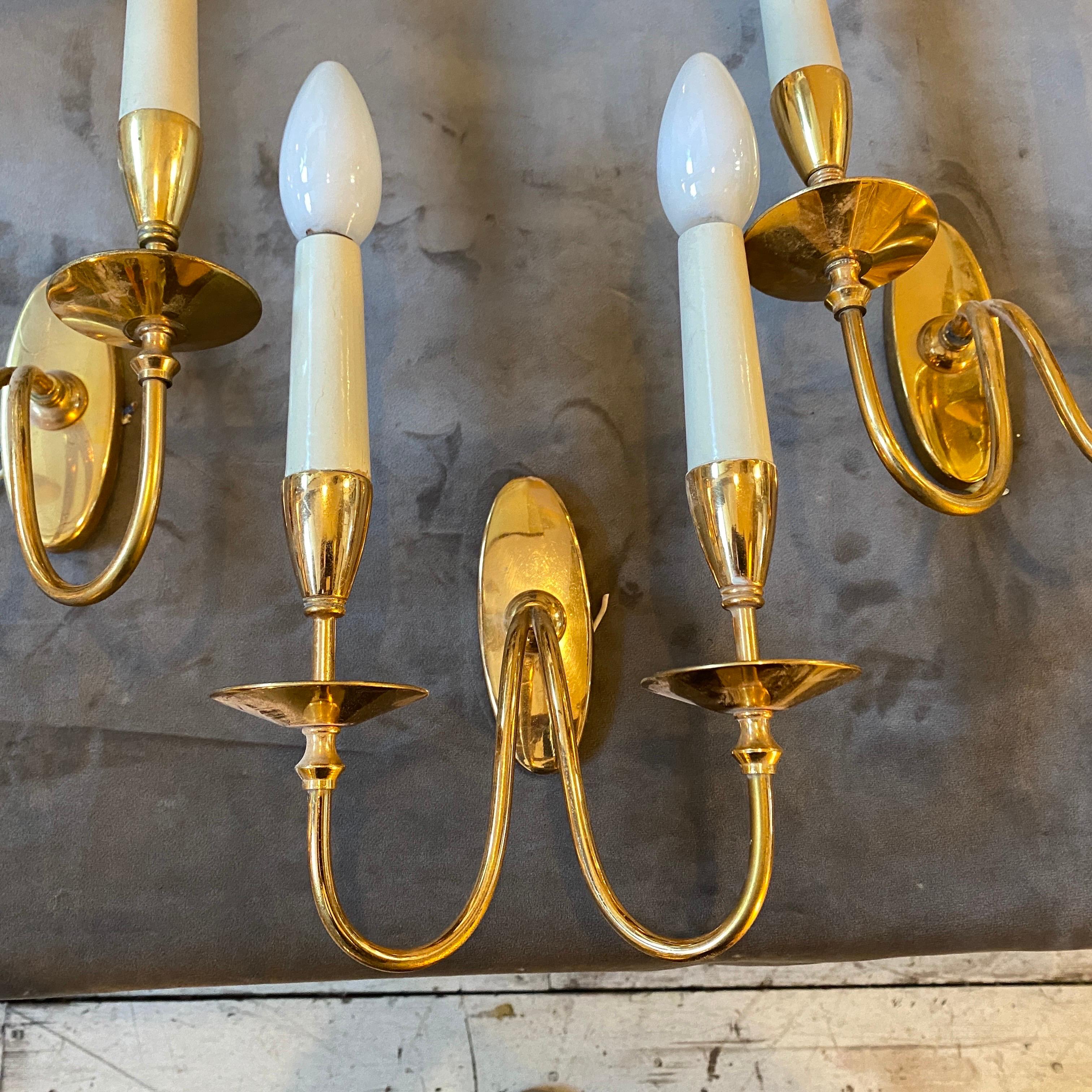 Set of four high quality solid brass wall sconces designed and manufactured in Italy in the Sixties by Bruno Chiarini. They are marked on the back part, they work 110-240 volts and need regular e14 bulbs.