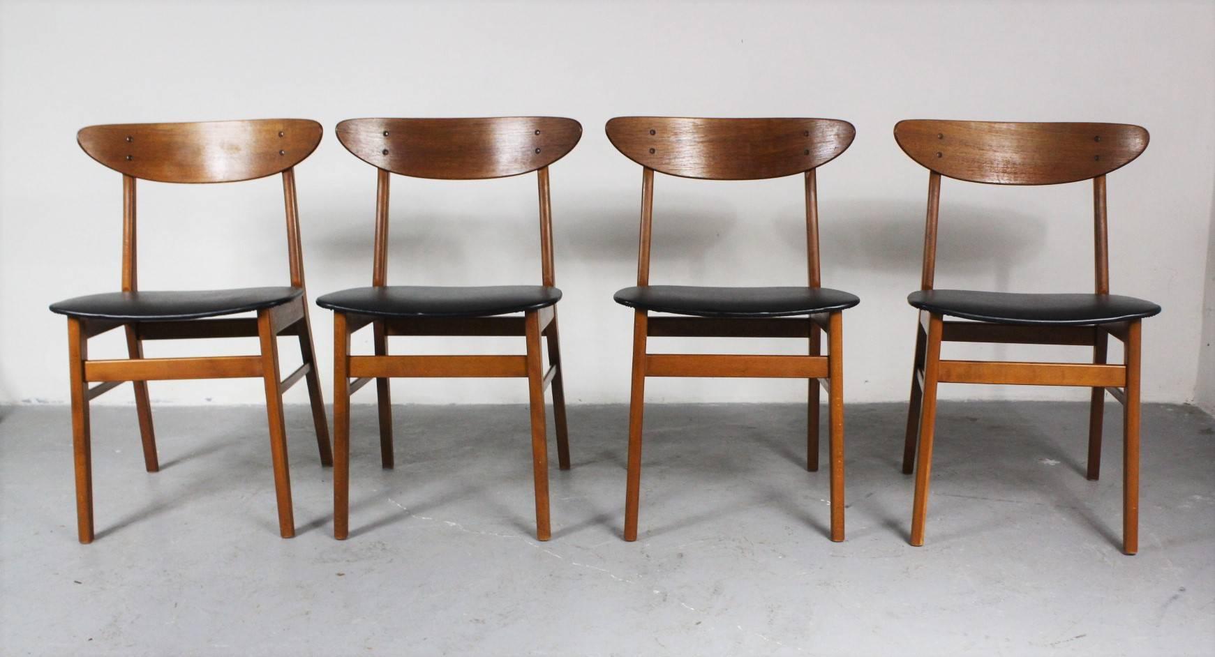 Set of four dining chairs from the 1960s from Denmark. Material is teak and beech, upholstered with faux leather. Chairs are in very good condition.