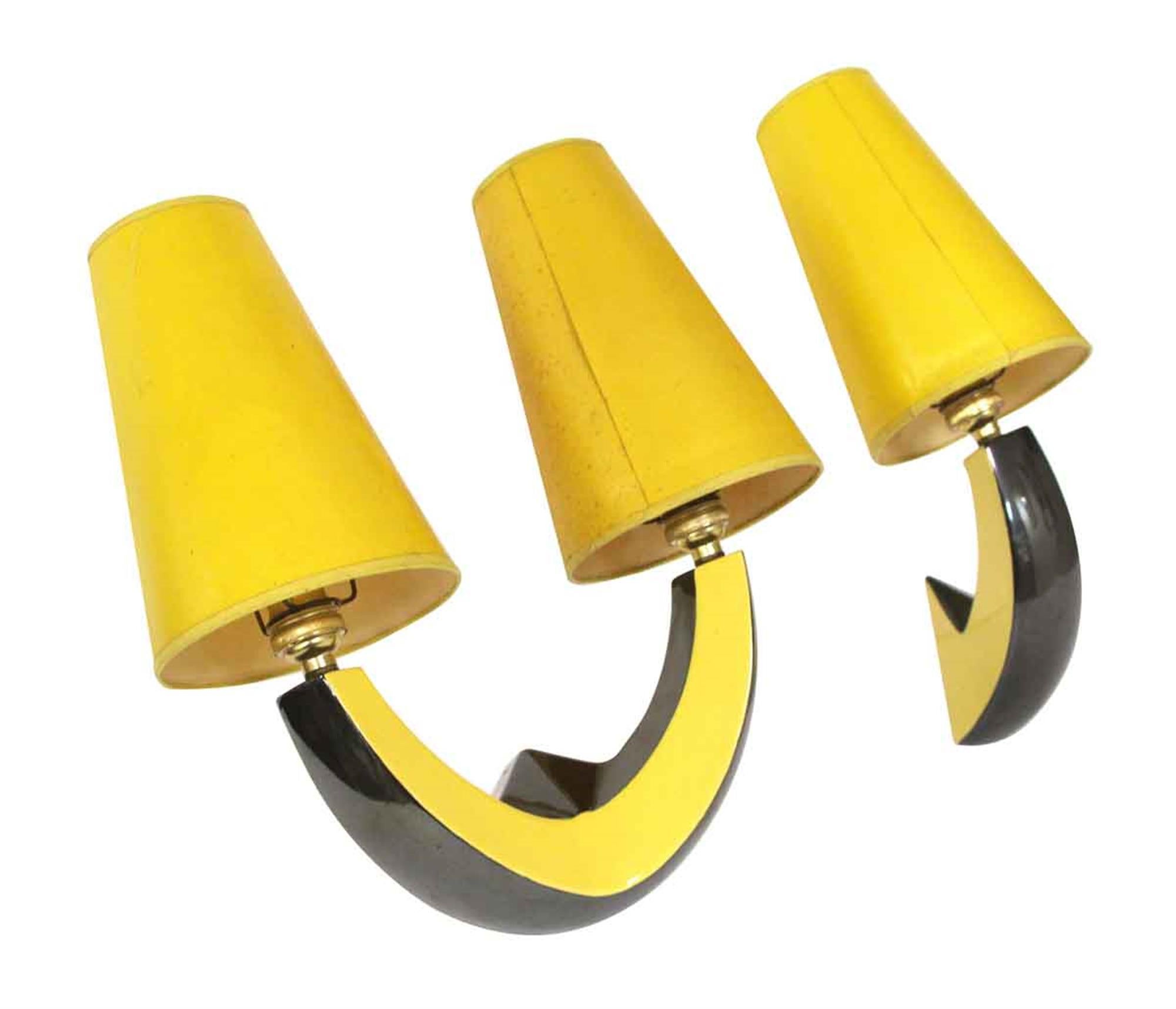 Ceramic black and yellow Mid-Century Modern style sconce set with yellow shades. From France. One sconce has two arms and one is a single arm. Needs re-wiring for the US. This can be seen at our 400 Gilligan St location in Scranton, PA.