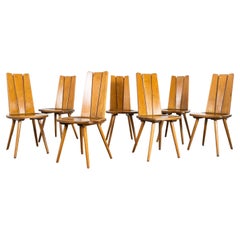 Ensemble de sept chaises de salle à manger françaises à dossier à lamelles, années 1960