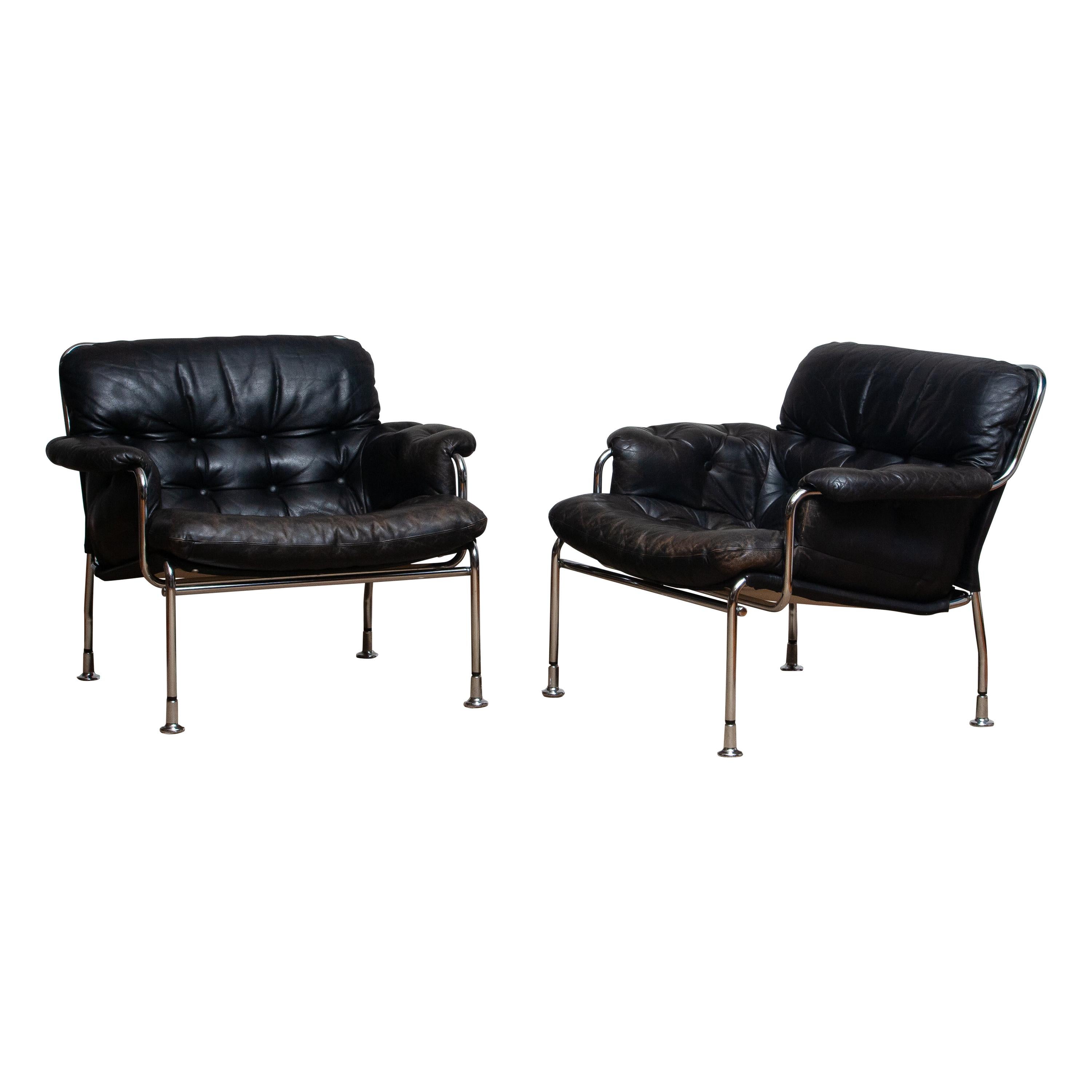 Mid-Century Modern 1960s Set of Two Eva Lounge Chairs in Chrome and Aged Black Leather by Lindlöfs