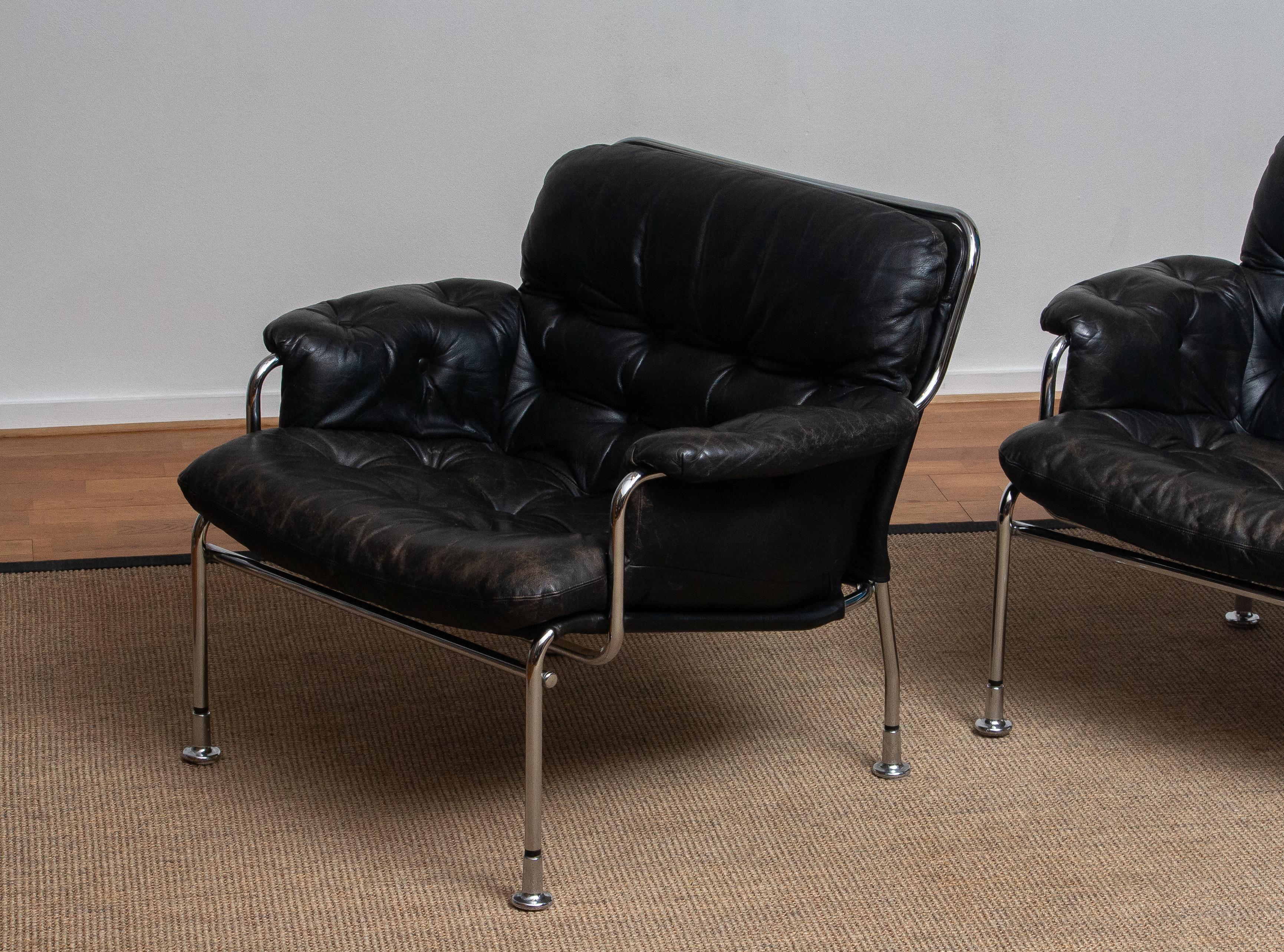 Swedish 1960s Set of Two Eva Lounge Chairs in Chrome and Aged Black Leather by Lindlöfs