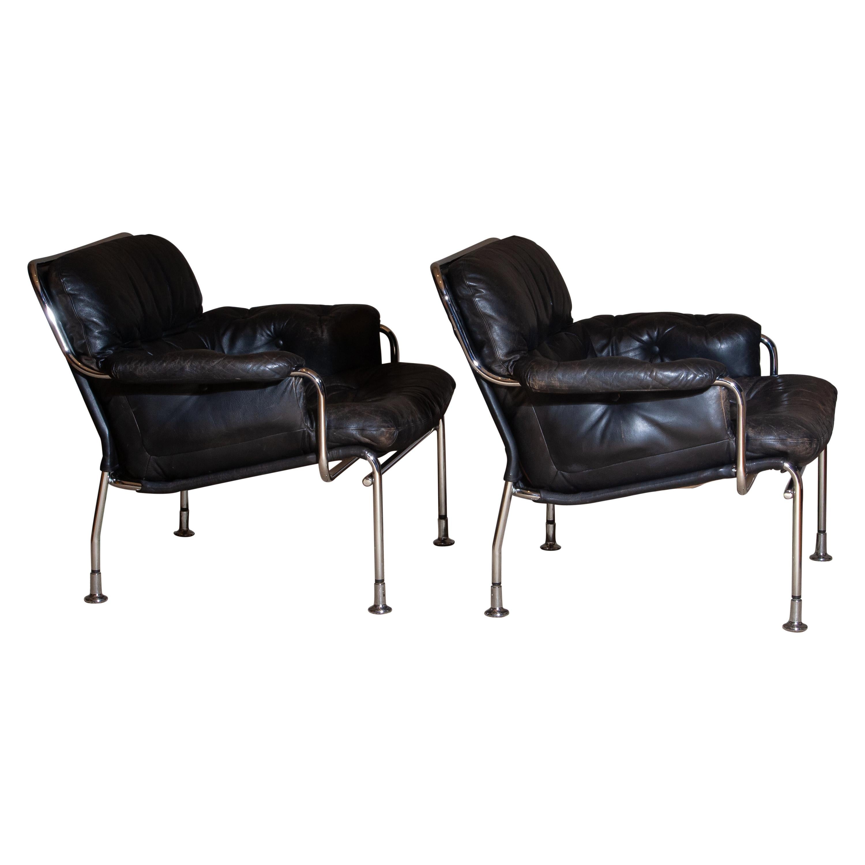Swedish 1960s Set of Two Eva Lounge Chairs in Chrome and Aged Black Leather by Lindlöfs