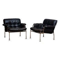 1960s Set of Two Eva Lounge Chairs in Chrome and Aged Black Leather by Lindlöfs