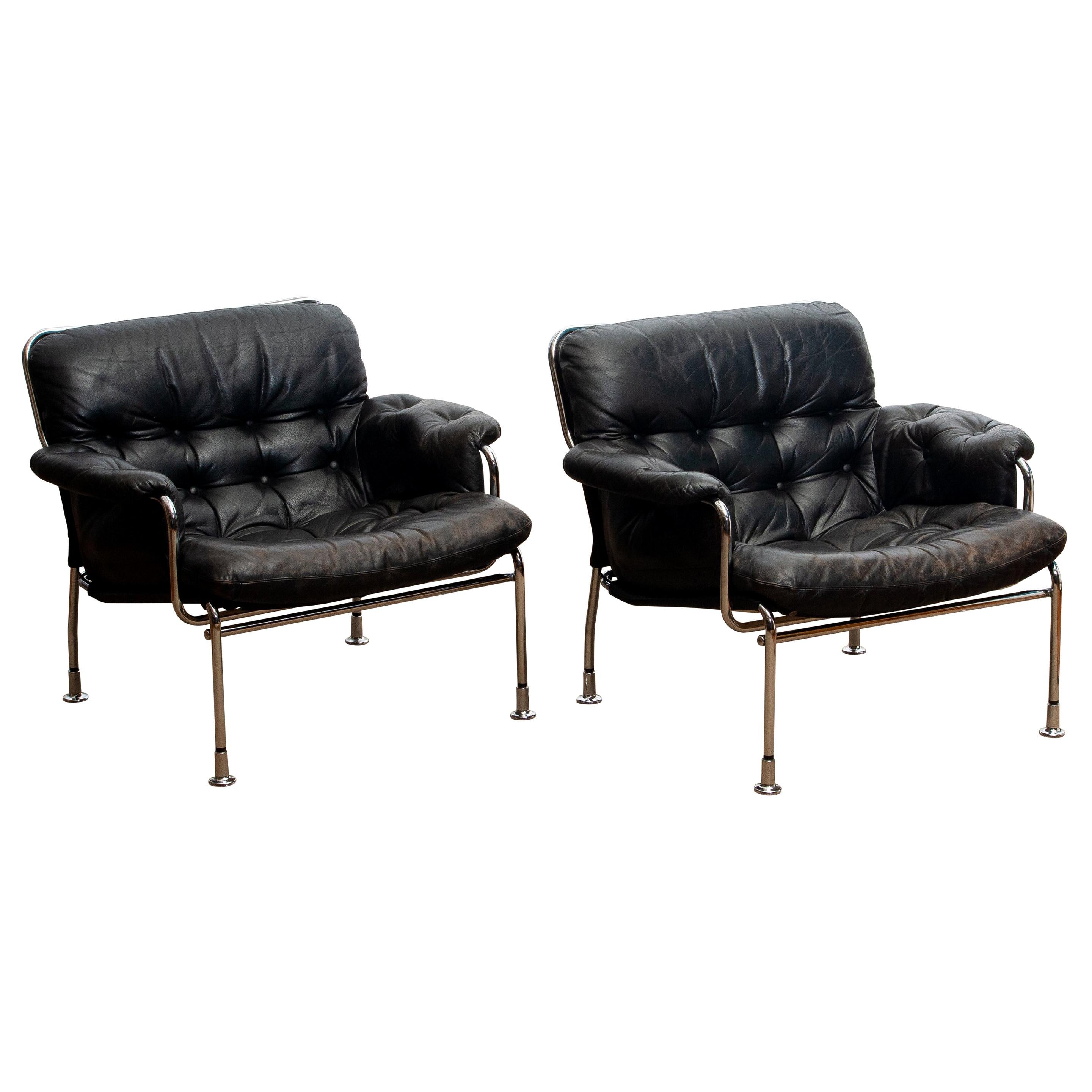 1960s Set of Two Eva Lounge Chairs in Chrome and Aged Black Leather by Lindlöfs