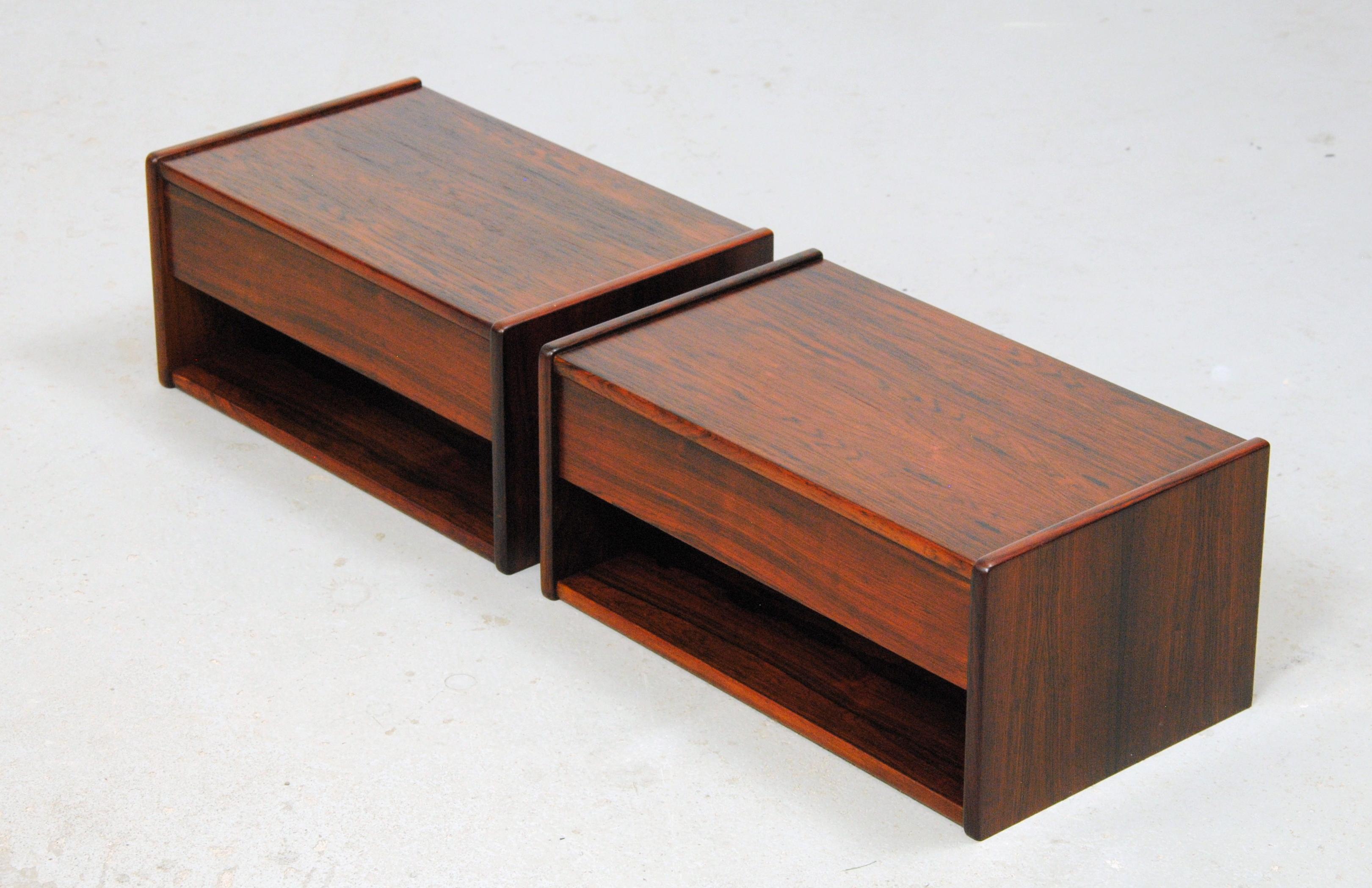 Set of two fully restored Danish floating rosewood nightstands.

The nightstands are examples of the minimalistic and functional yet beautiful design and advanced craftmanship that characterized Danish midcentury Furniture. 

The nightstands