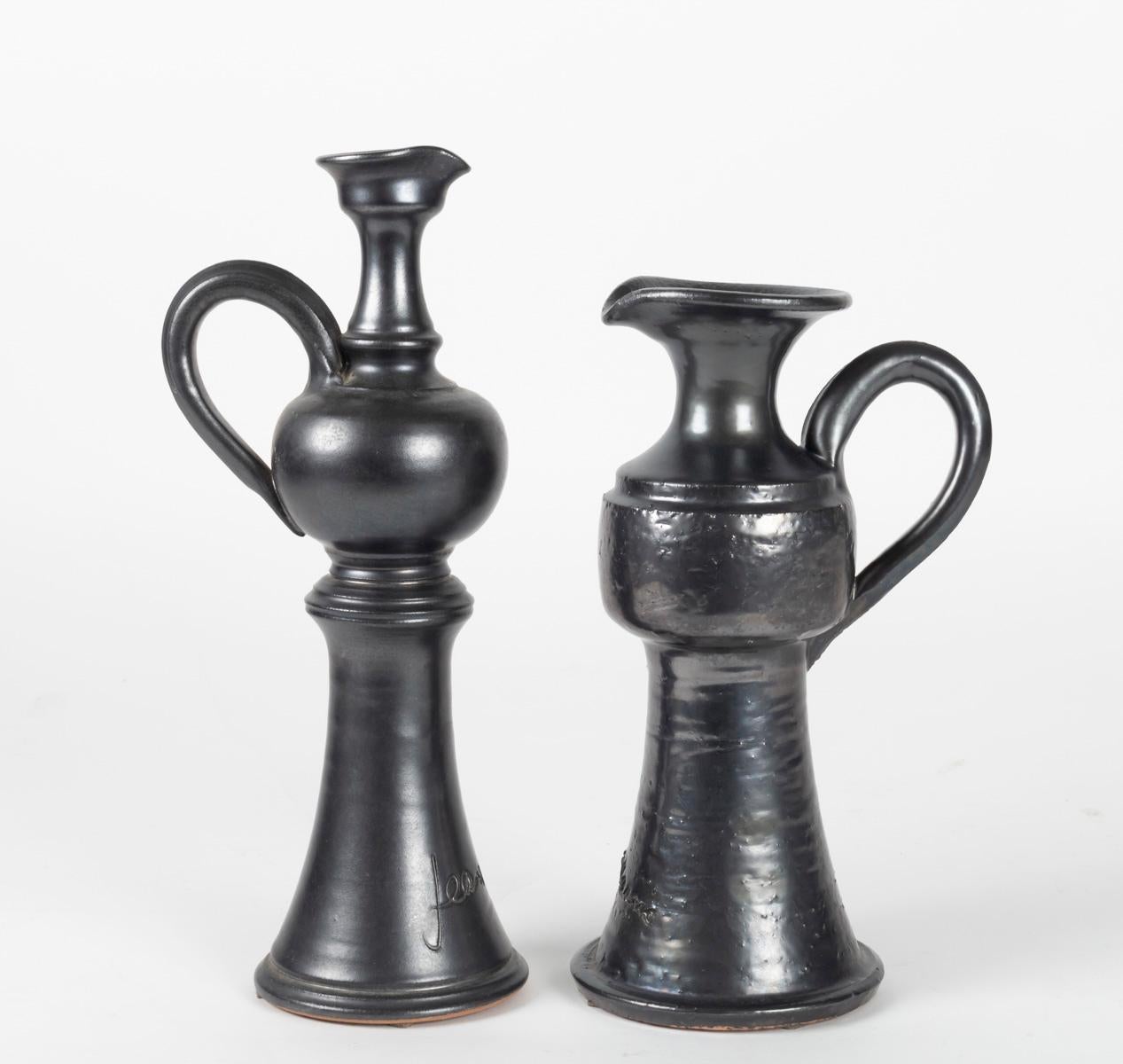 The set is composed by two jugs with different heights.
They feature a black enameled finish and the Jean Marais signature.
  