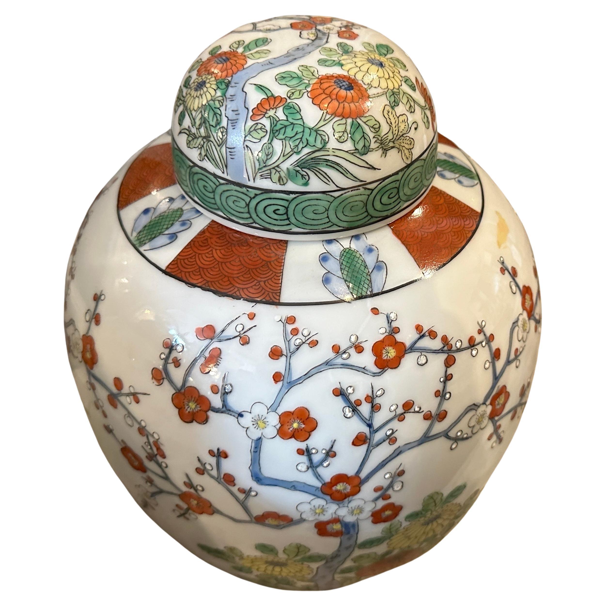 Two hand painted ginger jars hand-crafted in China in the mid-20th century. The decor depicts traditional chinese flowers, the are in lovely condition and marked on the bottom .Hand-painted ginger jars crafted in China during the mid-20th century