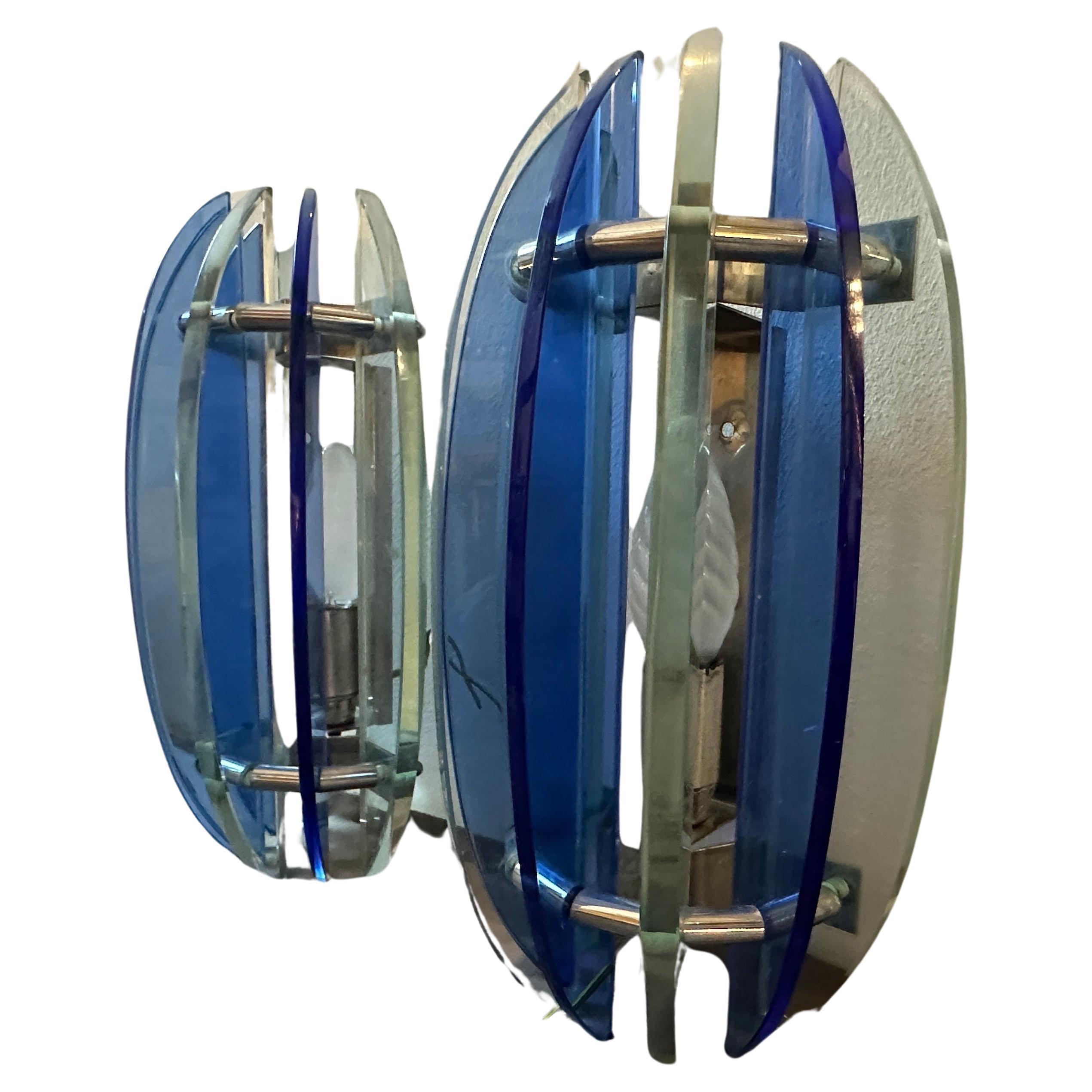A pair of iconic wall sconces designed and manufactured in Italy by Veca in the Space Age Era, they are in perfect condition and in working order.This set of Wall Sconces by Veca it's a striking representation of mid-century modern design. They are