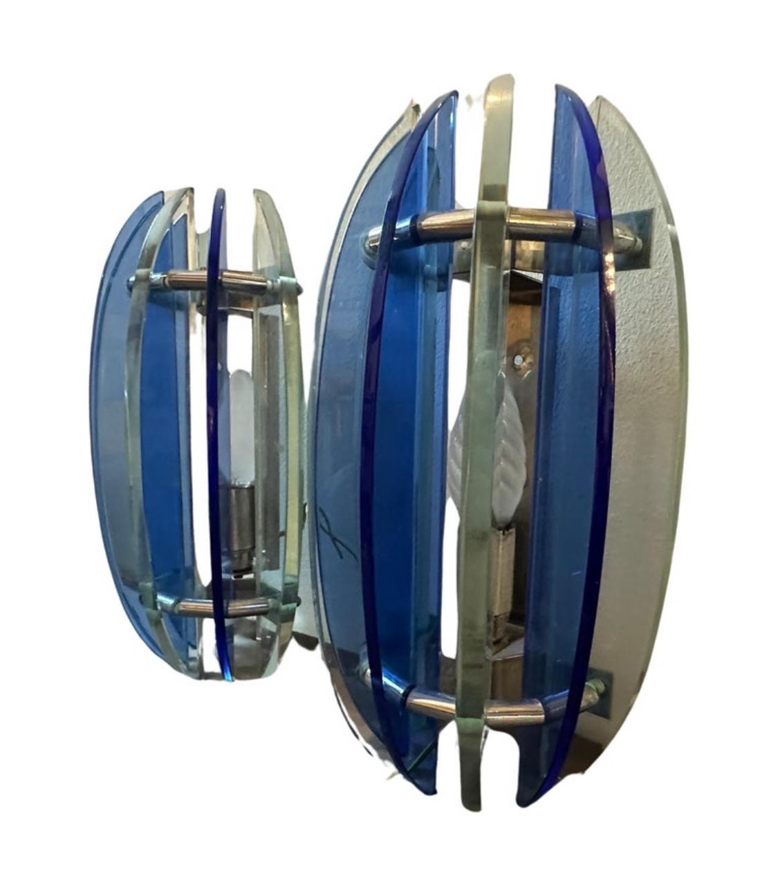 A pair of iconic wall sconces designed and manufactured in Italy by Veca in the Space Age Era, they are in perfect condition and in working order.This set of Wall Sconces by Veca it's a striking representation of mid-century modern design. They are