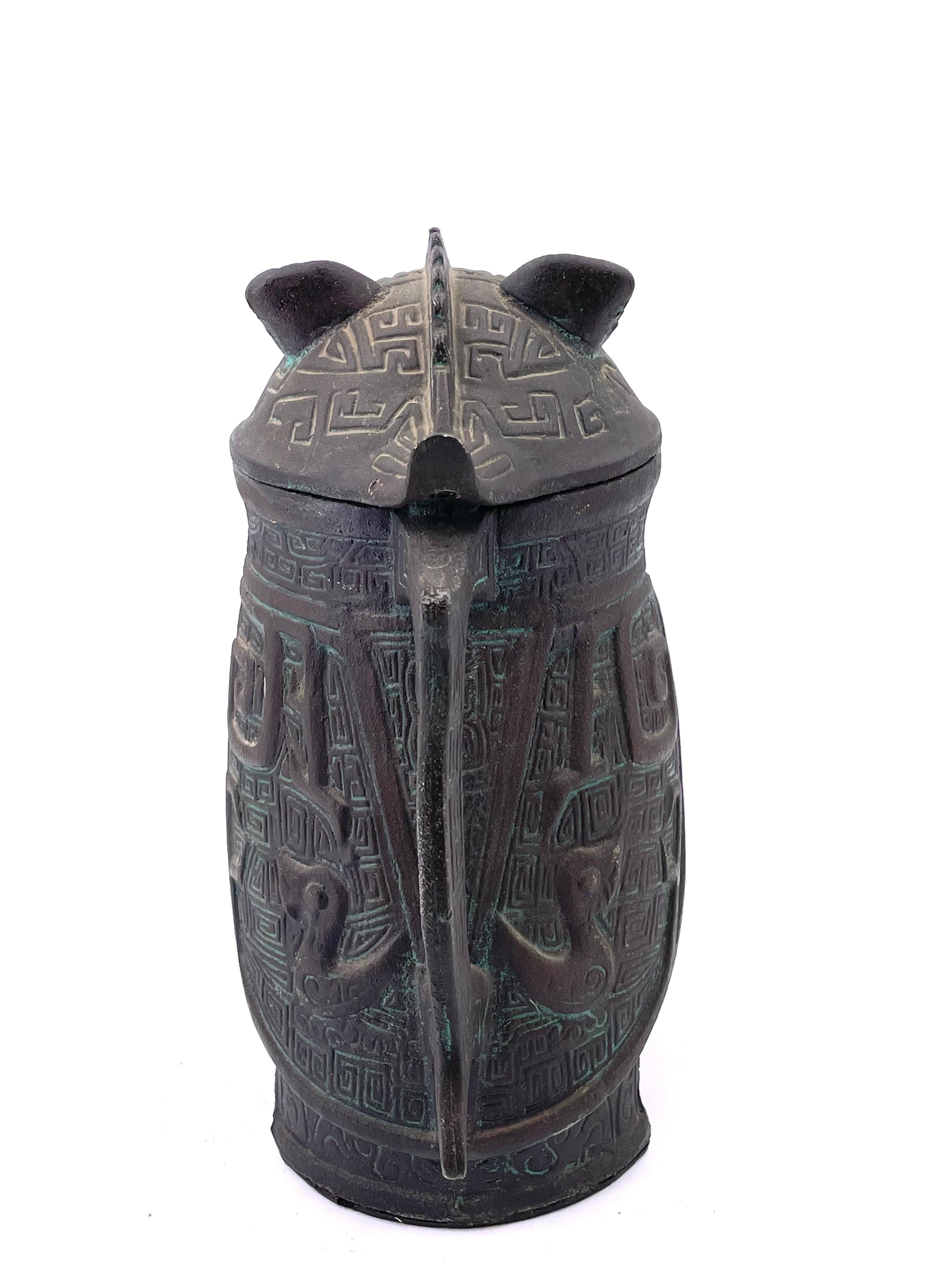 Cast metal with inner plastic and a patinated bronze finish, Chinese owl decanter pitcher circa 1960's by Getz Brothers.
