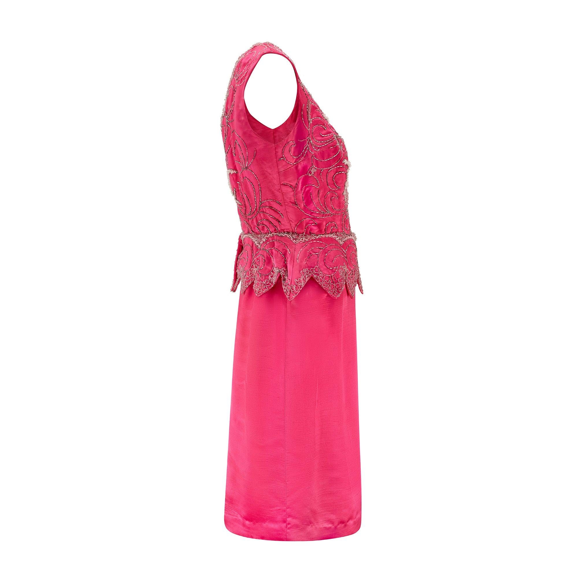 Cette robe de cocktail rose vif en satin et soie a conservé toute la vivacité de l'époque où elle a été conçue. Il s'agit vraisemblablement d'une pièce de couture ou sur mesure fabriquée en Grande-Bretagne au milieu des années 1960. Le tissu de