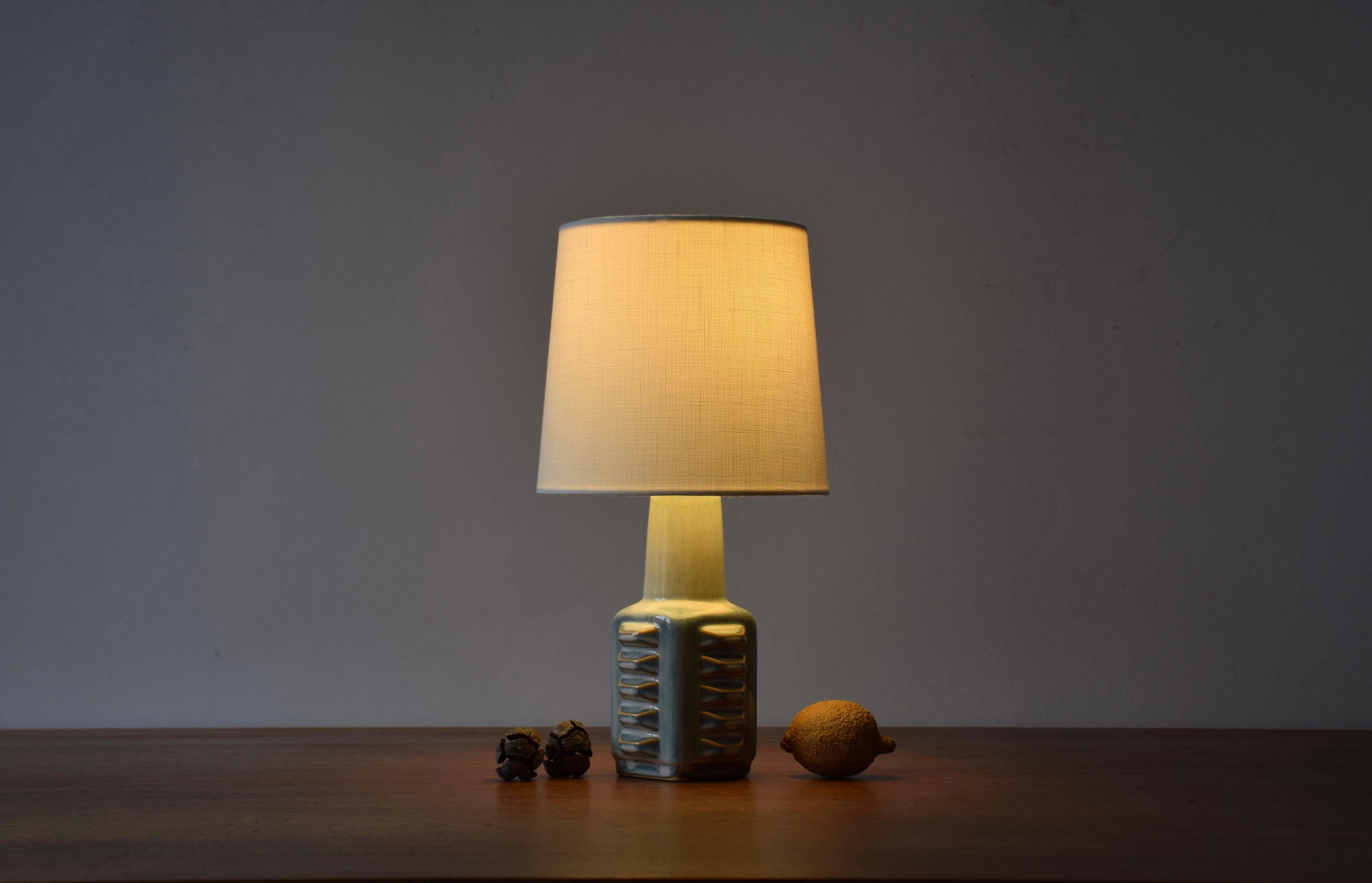 Small sculptural table lamp from Søholm Stentøj, Denmark.
Designed by Einar Johansen and made circa 1960s.
Great play of glaze colors pale blue, purple and beige.

Included is a new clip-on-bulb lamp shade designed and made in Denmark. It is made of