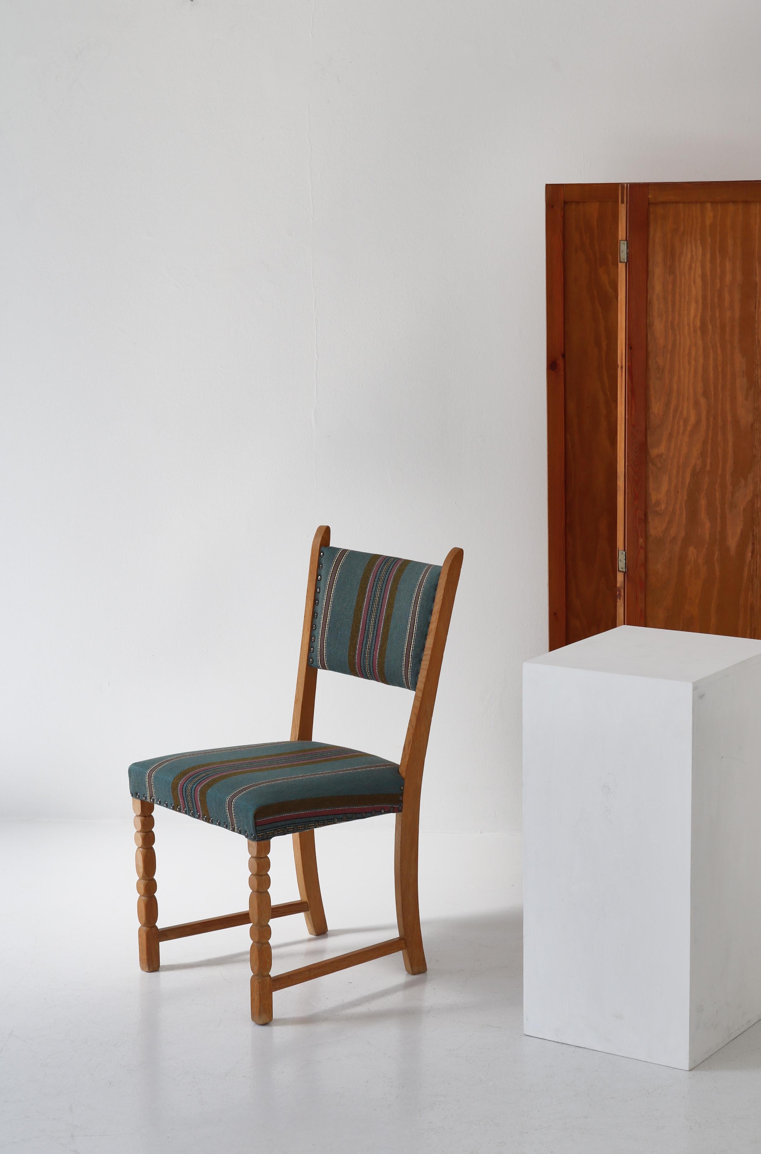 Vintage side chair in solid patinated Scandinavian oak tree and wonderful vintage wool upholstery. This model was designed in the 1960s and is ascribed to Henry Kjærnulff, Denmark. The style is modern but with playful hints to historical chairs. The