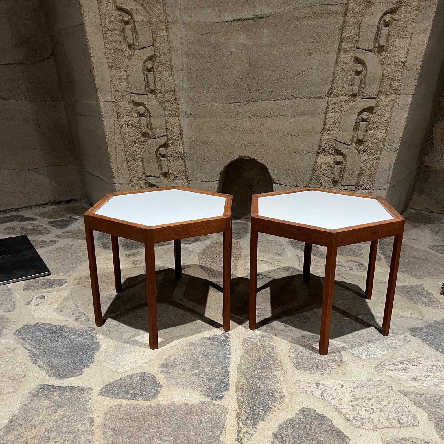 Side Tables by Hans Andersen. Made in Denmark circa 1960s. 
Solid Teak and white Formica Hexagonal Tables
Stamped MADE IN DENMARK
14.5 tall x 19.25 diameter 16.75 x 16.75
Preowned vintage overall good condition. Recently oiled.
Expect light