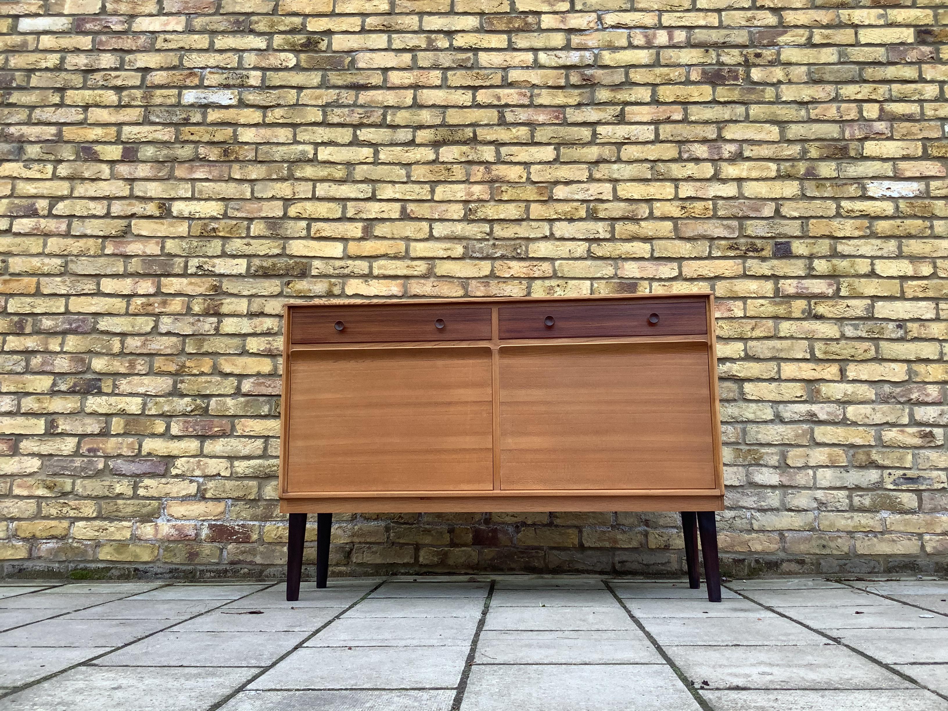 Rare midcentury Gordon Russell sideboard from the 1950s-1960s. Great compact size. A really well made, high quality, and increasingly rare piece of British manufacturing and design. 

This compact sideboard features a cabinet section with two twin