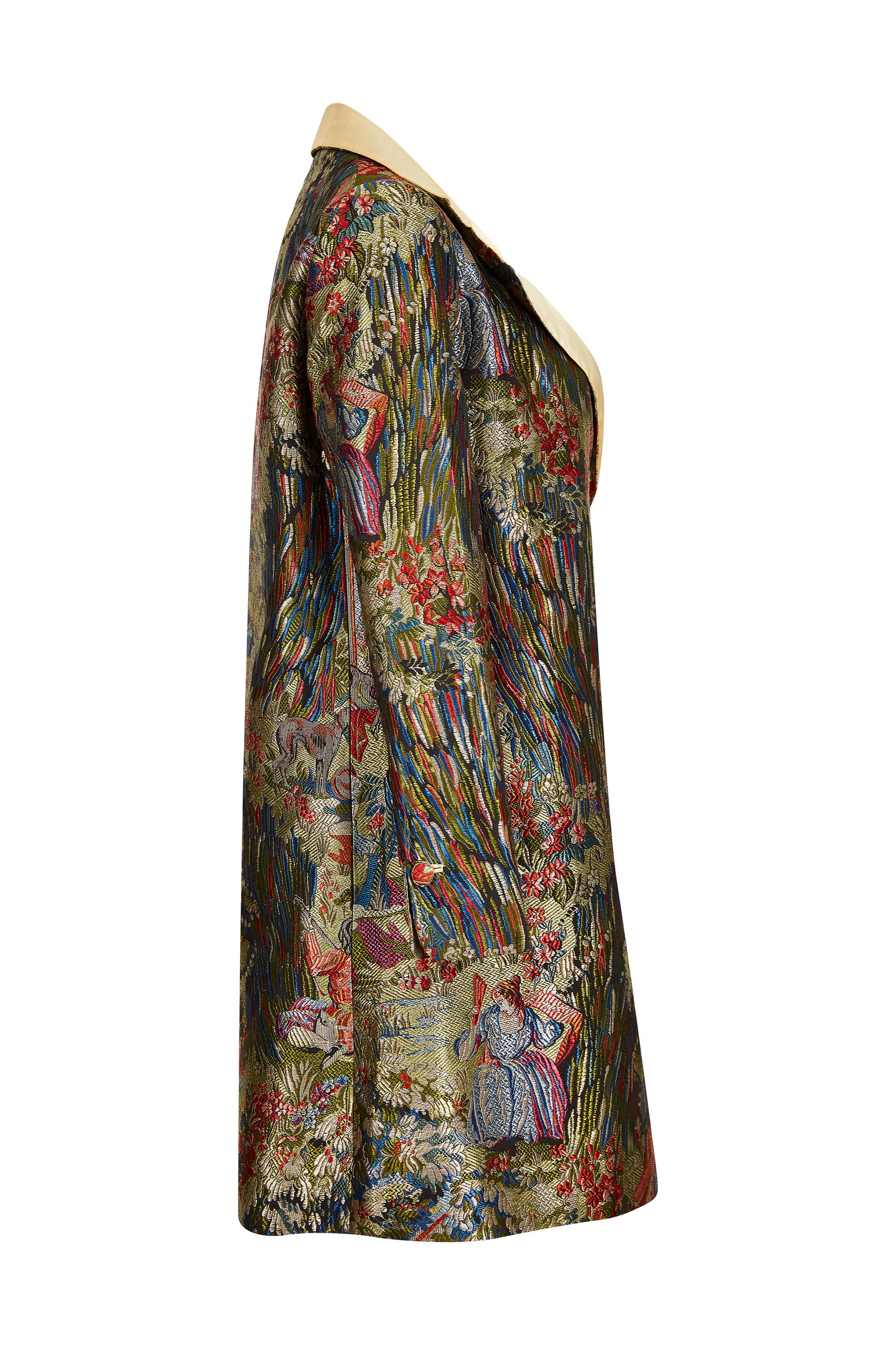 This stylish early 1960s silk brocade jacket with silk lining and collar detail is unlabelled, however, is of exceptional quality and in immaculate vintage condition. The jacket is designed to be worn open and is a clean, elegant cut. It features a