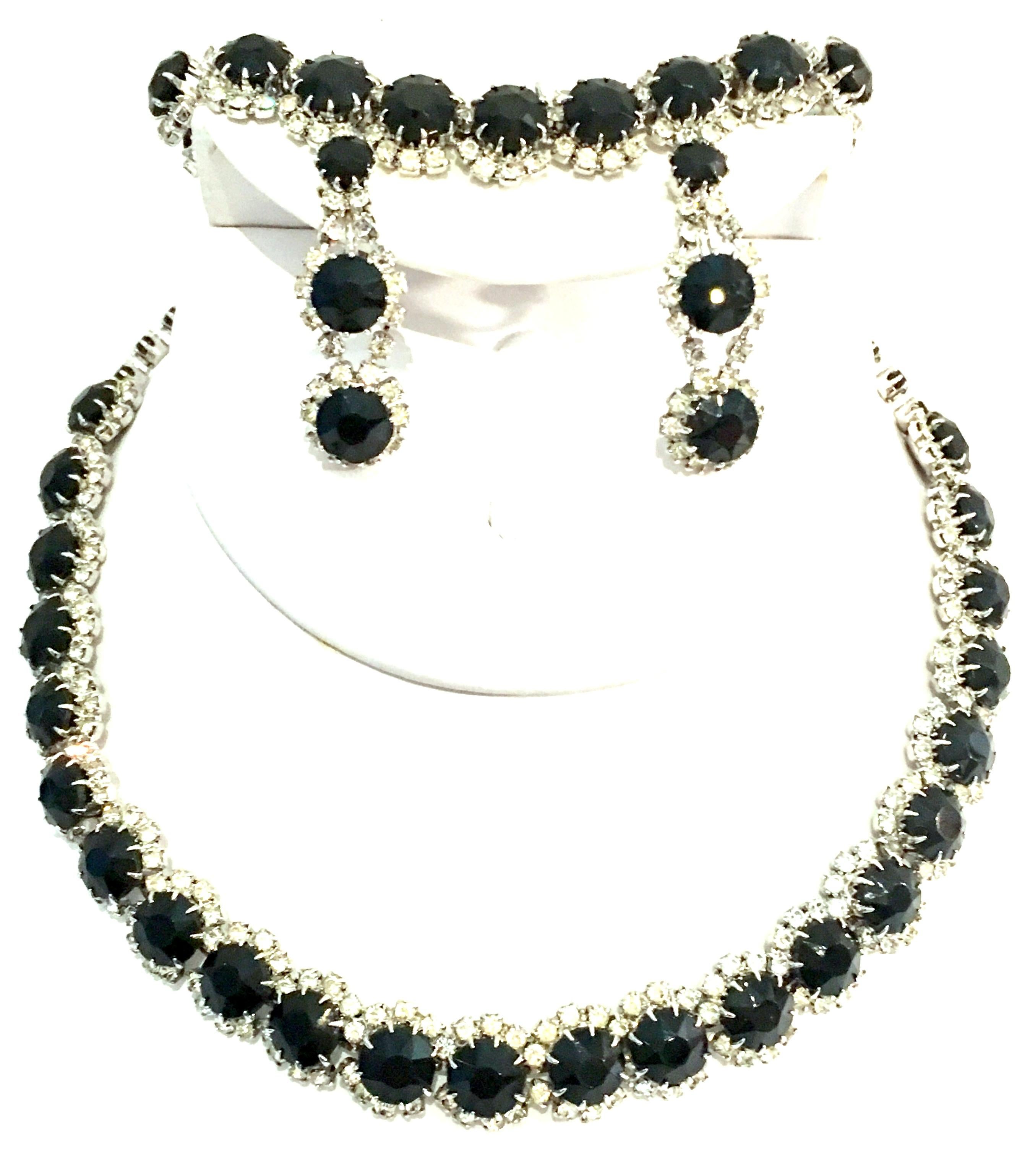 20th Century Silver & Austrian Crystal Necklace, Bracelet And Pair Of Earrings, Set Of Four Pieces By Kramer Of New York. This finely crafted demi-parure set of four pieces features silver rhodium plate fancy prong set brilliant cut and faceted