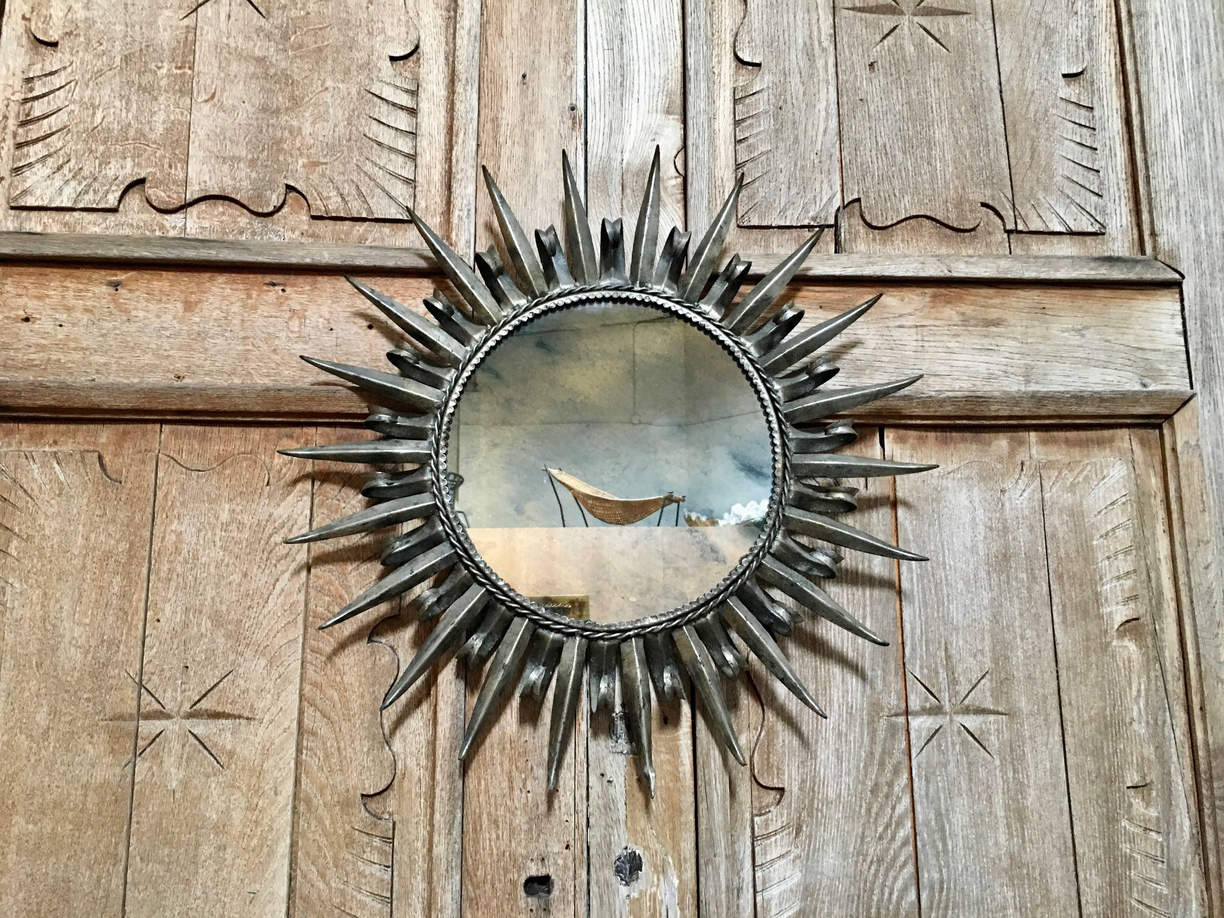 Vintage Italian sunburst silver finish metal frame with a antique style mirror.