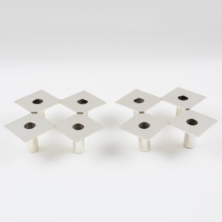 Very elegant 1960s modernist silver plate candlesticks or candleholders by Donna H. Detmer. Streamline and neat geometric shape with four silver plate insert holders in each candlestick. Perfect for any table either dining or cocktail. Marked