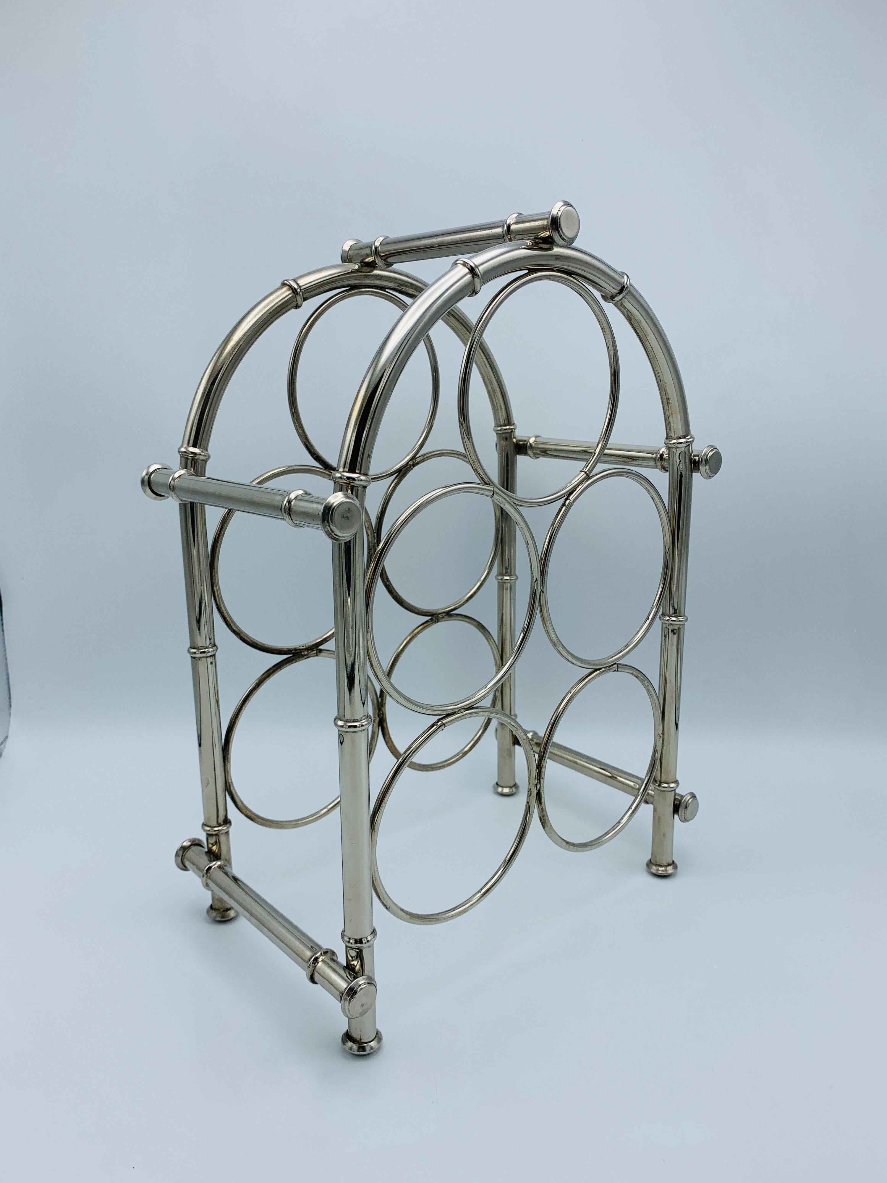 Listed is a fabulous, 1960s silver plate faux bamboo wine bottle rack. The piece has room for five standard sized bottles. Professionally polished. Heavy, 3lbs.