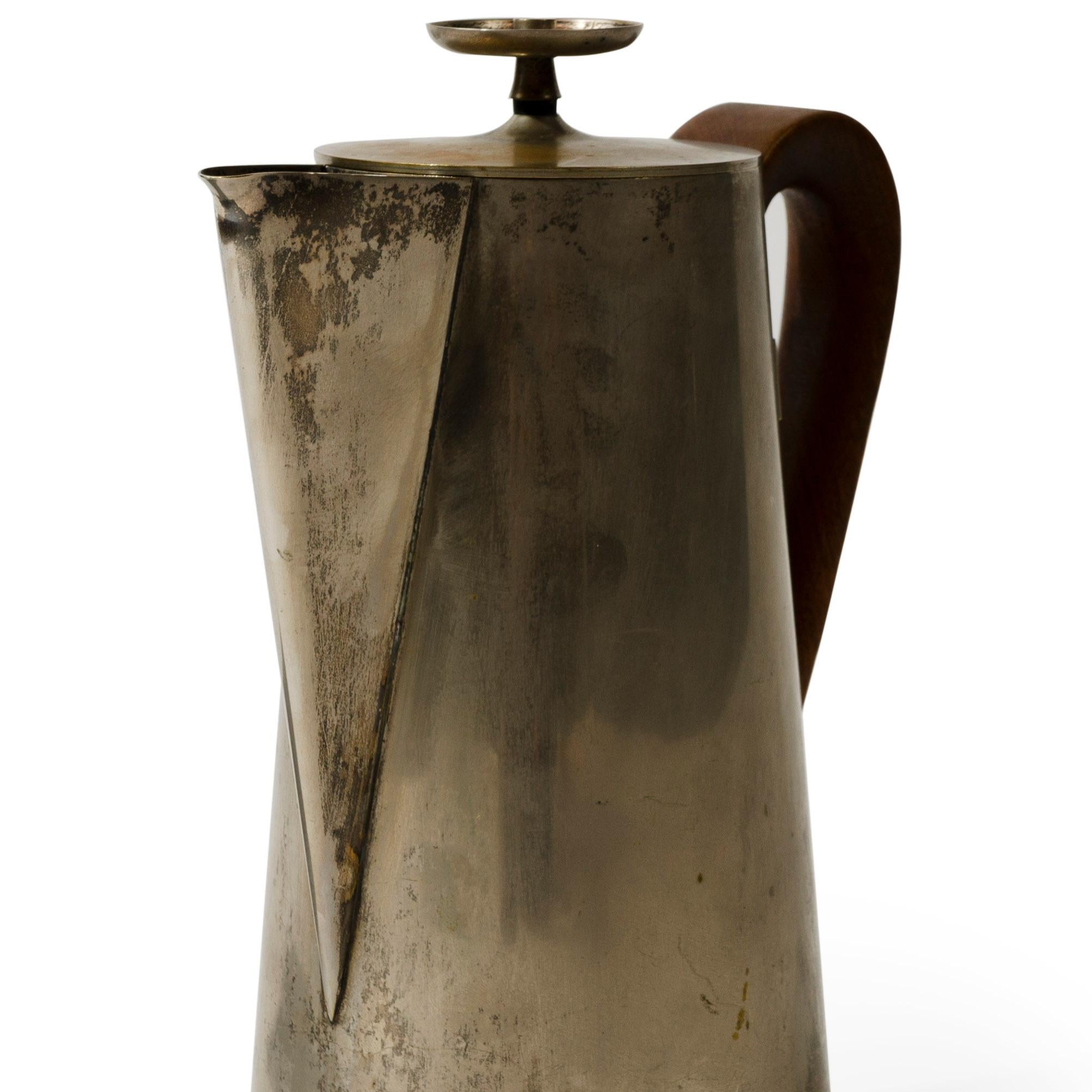 A silver plated brass tea pot with walnut handle and beautiful patina.