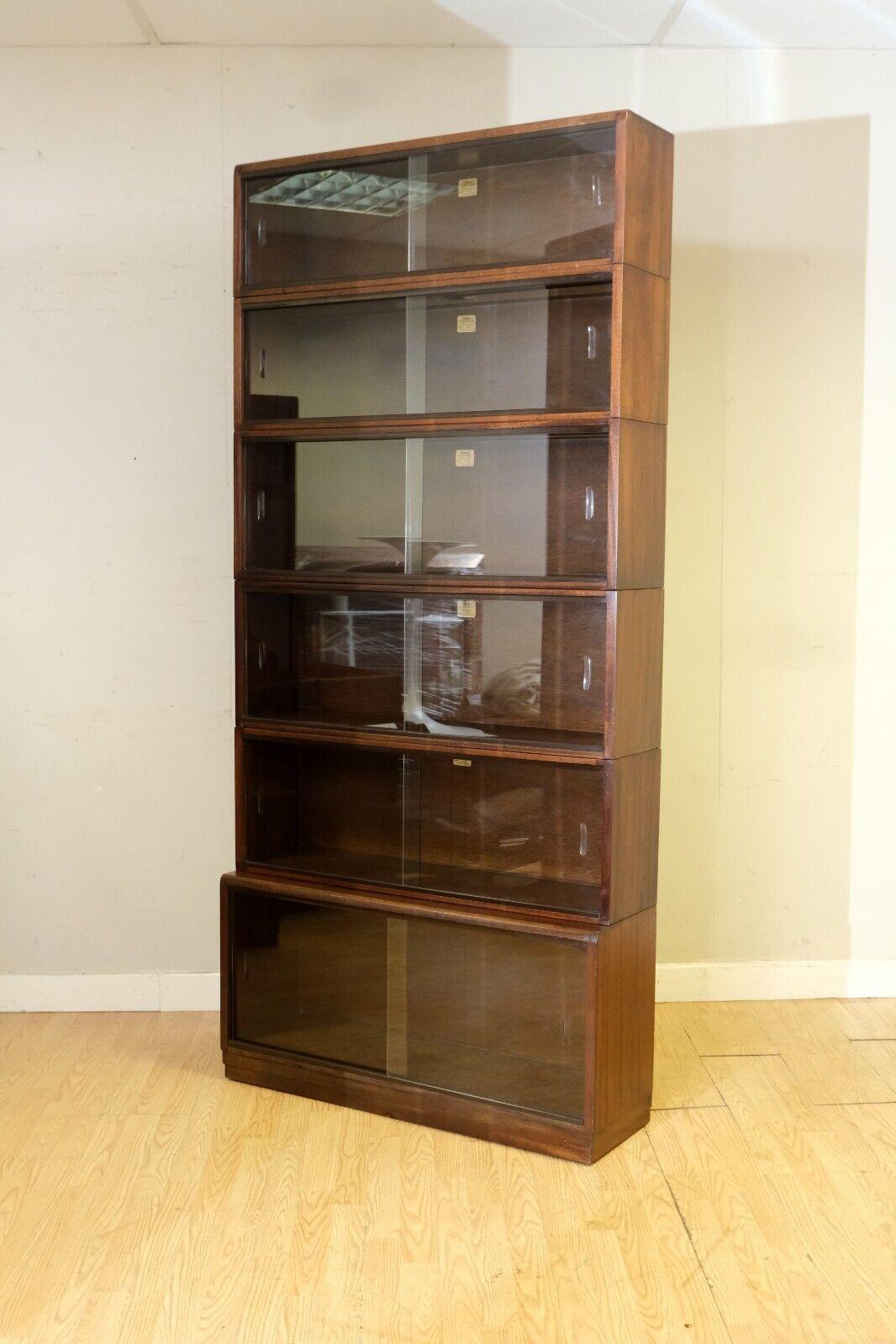 We are delighted to offer for sale this stunning, Simplex, six-piece, 1960's section bookcase in mahogany, with glass doors.

This is a great item in very good condition with two original glass sliding doors to each section, both free from chips.