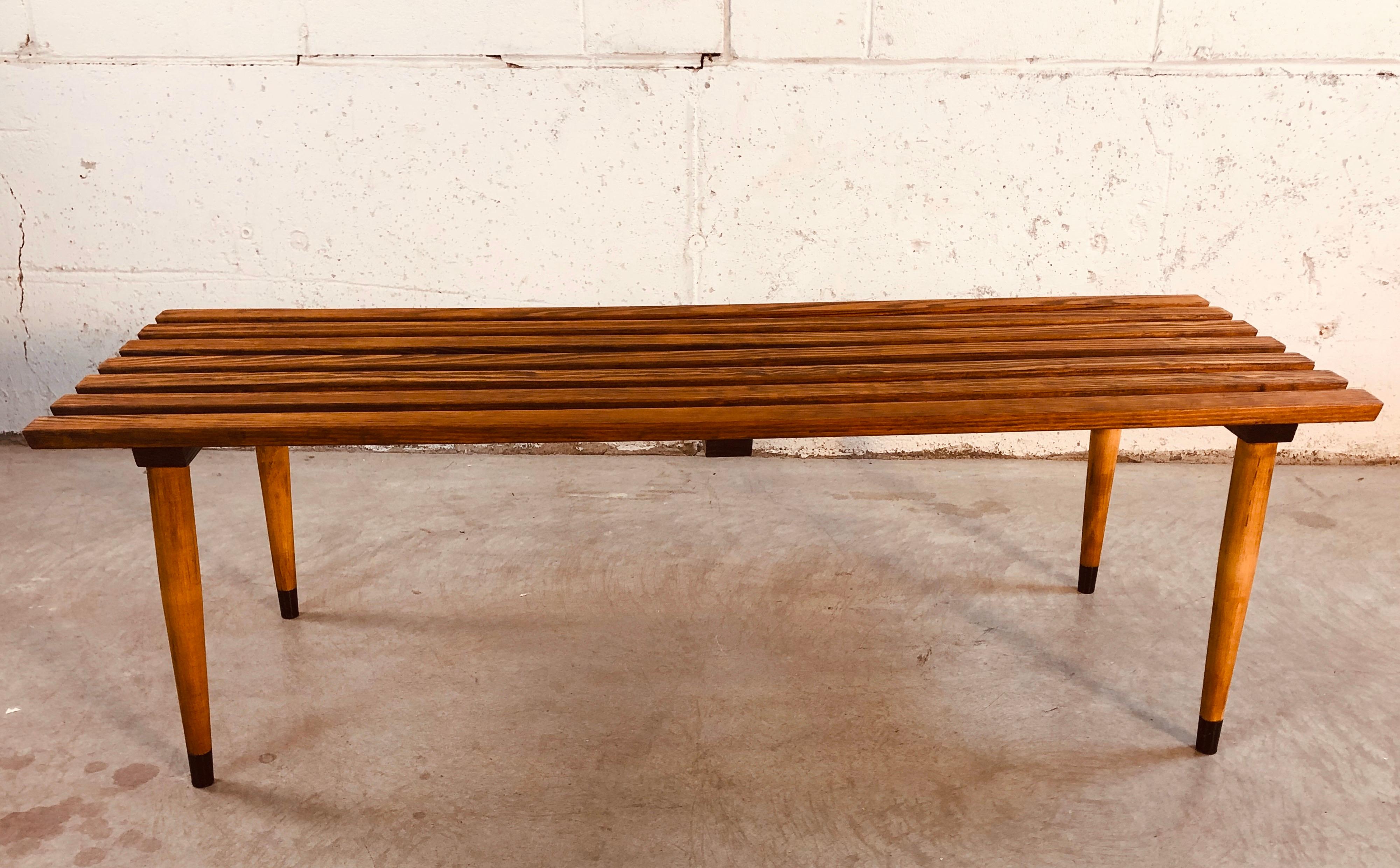 Vintage 1960s slat wood bench coffee table with round wood legs. Fully restored condition. No marks.