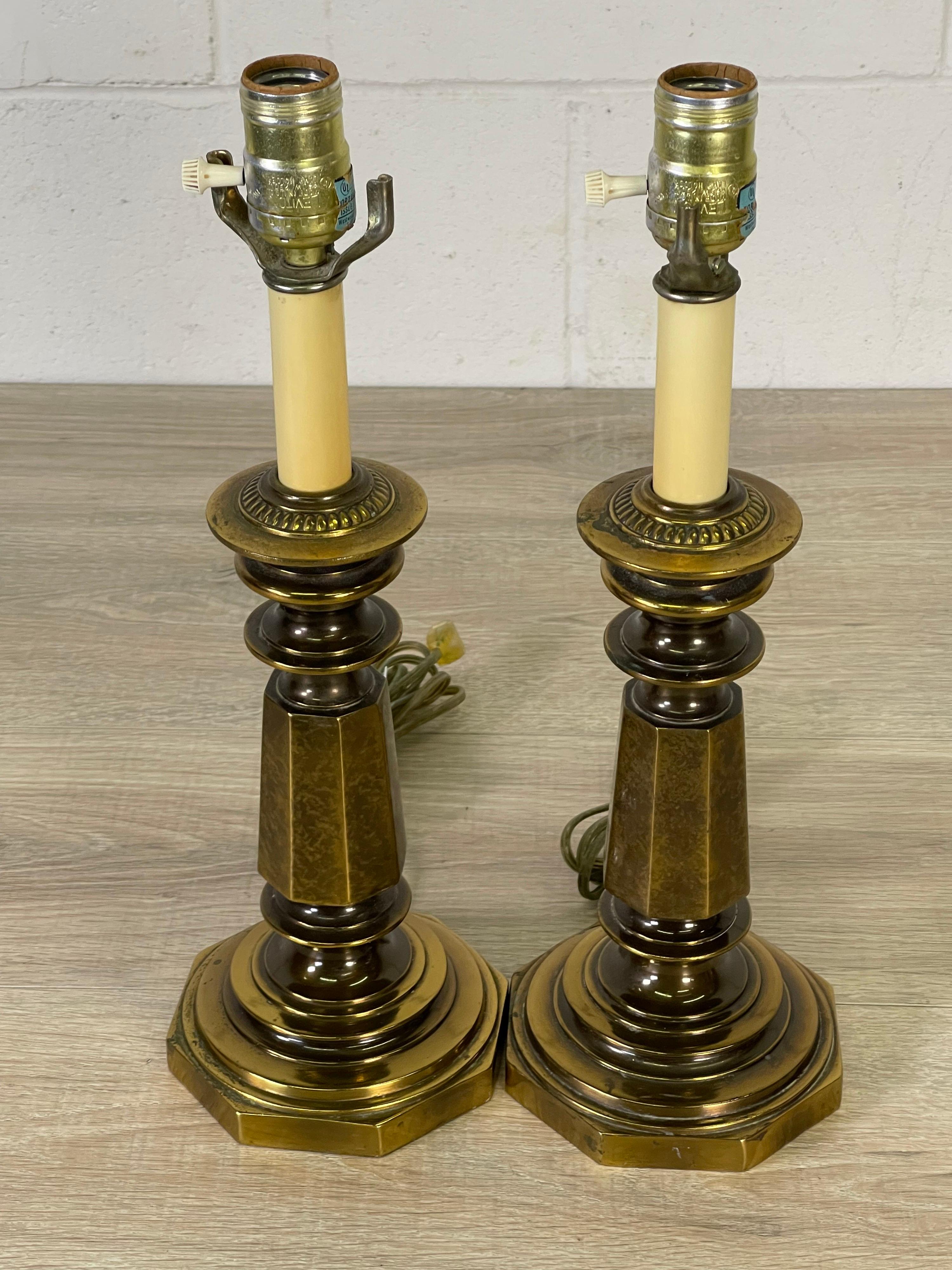 Vintage pair of small brass table lamps. The lamps are wired for the US and in working condition. They use a standard 100 watt bulb and can also support a 3-way bulb. Harps are not included. Marked.