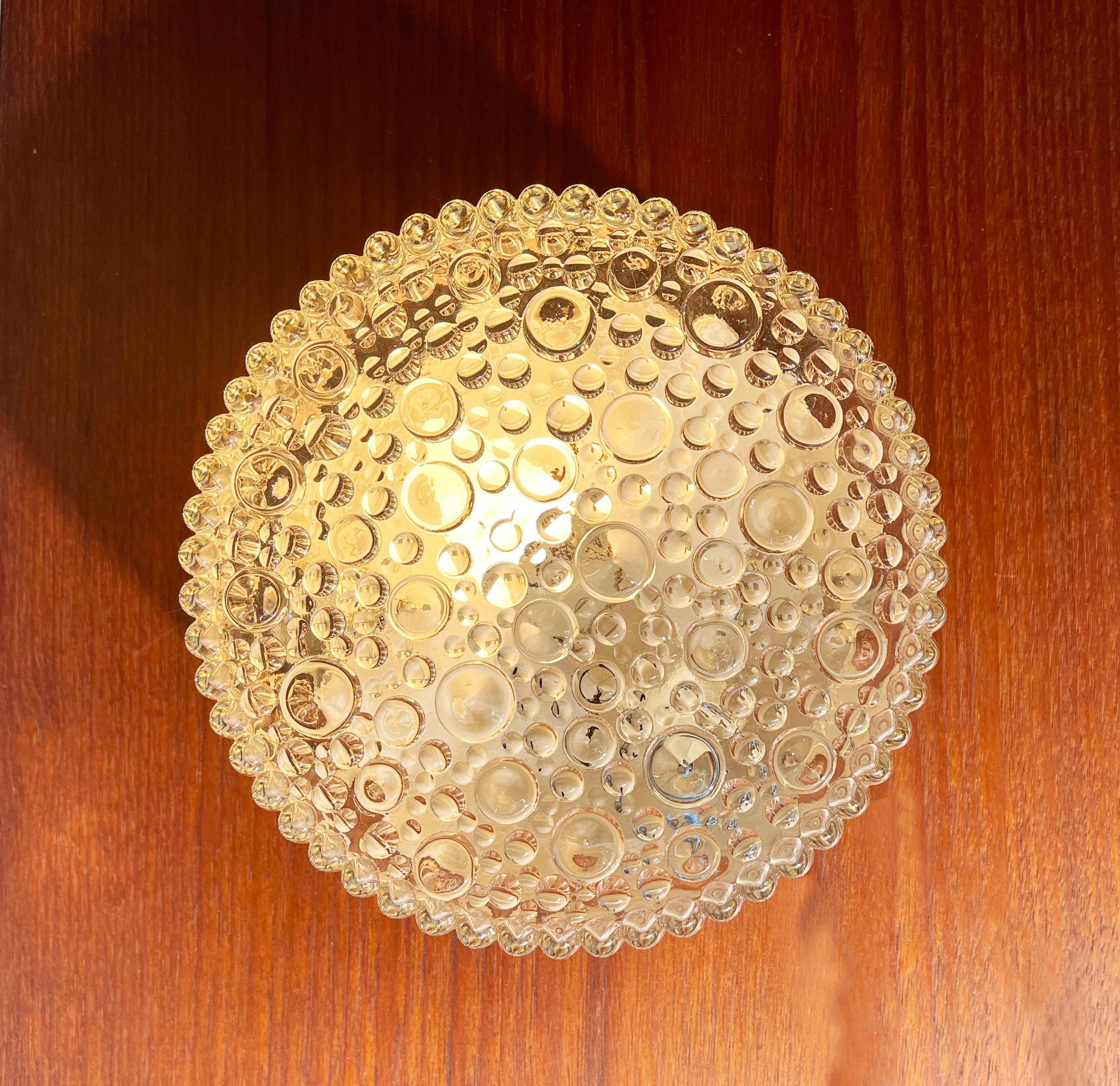 Gorgeous flush base ceiling or wall lamp in the style of Helena Tynell. 
Comes in a round shape with the bubbles growing on ''stems''.
Beautiful warm light, funky original German mid-century design.

Can be wall or ceiling mounted.
The glass shade