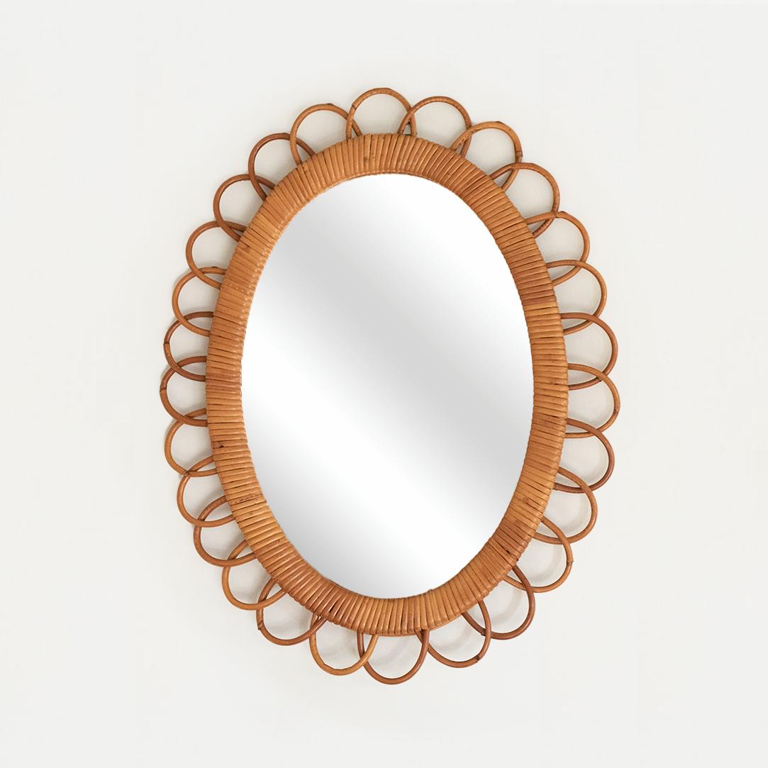 Small size rattan mirror in an oval shape with looped rattan encompassing the mirror. Nice vintage condition with original mirror. From Italy, 1960's.