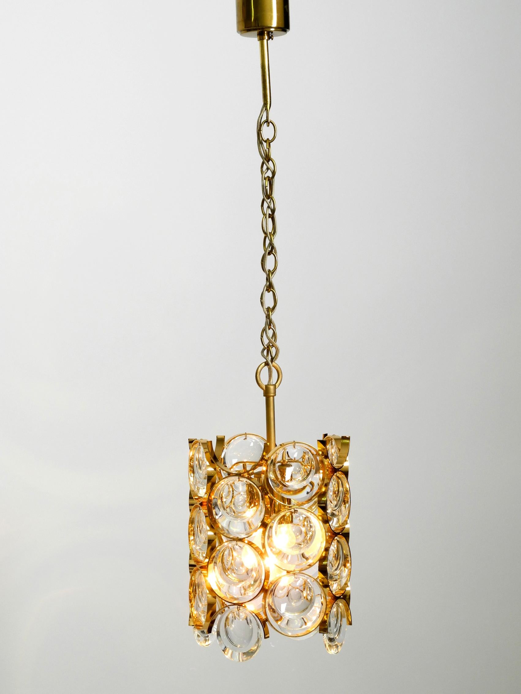 Beautiful very luxurious 1960s small Palwa ceiling pendant lamp with heavy brass frame and large crystal stones. Lamp frame, chain and canopy are made of brass. It has been manufactured by Palme & Walter in the 1960s. Made in Germany. Shiny brass