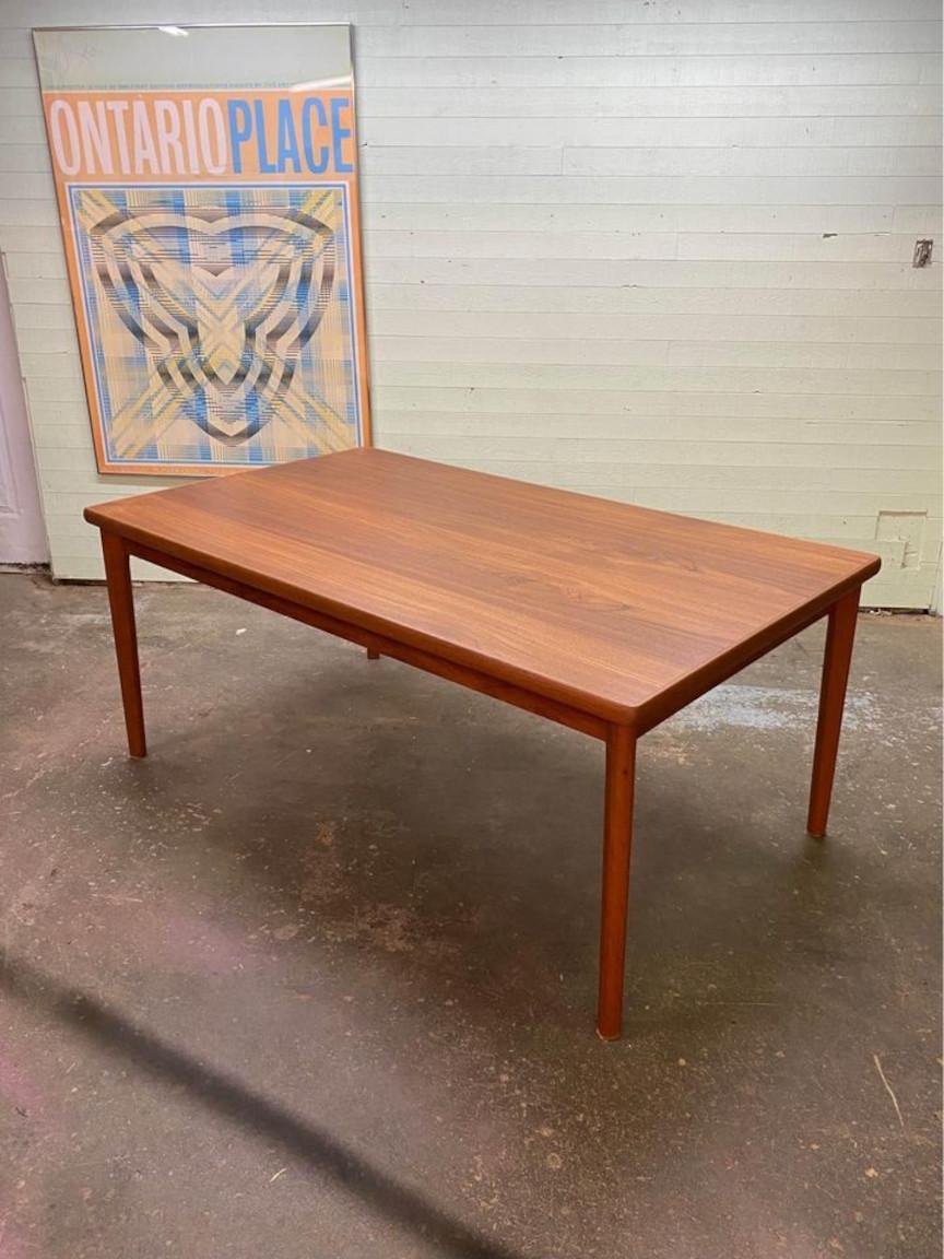 A distinctive small-scale Scandinavian teak dining table, this compact gem boasts two self-storing leaves, sleek straight tapered legs, and a subtly polygonal-shaped surface. Recently, our dedicated team conducted a meticulous restoration, ensuring
