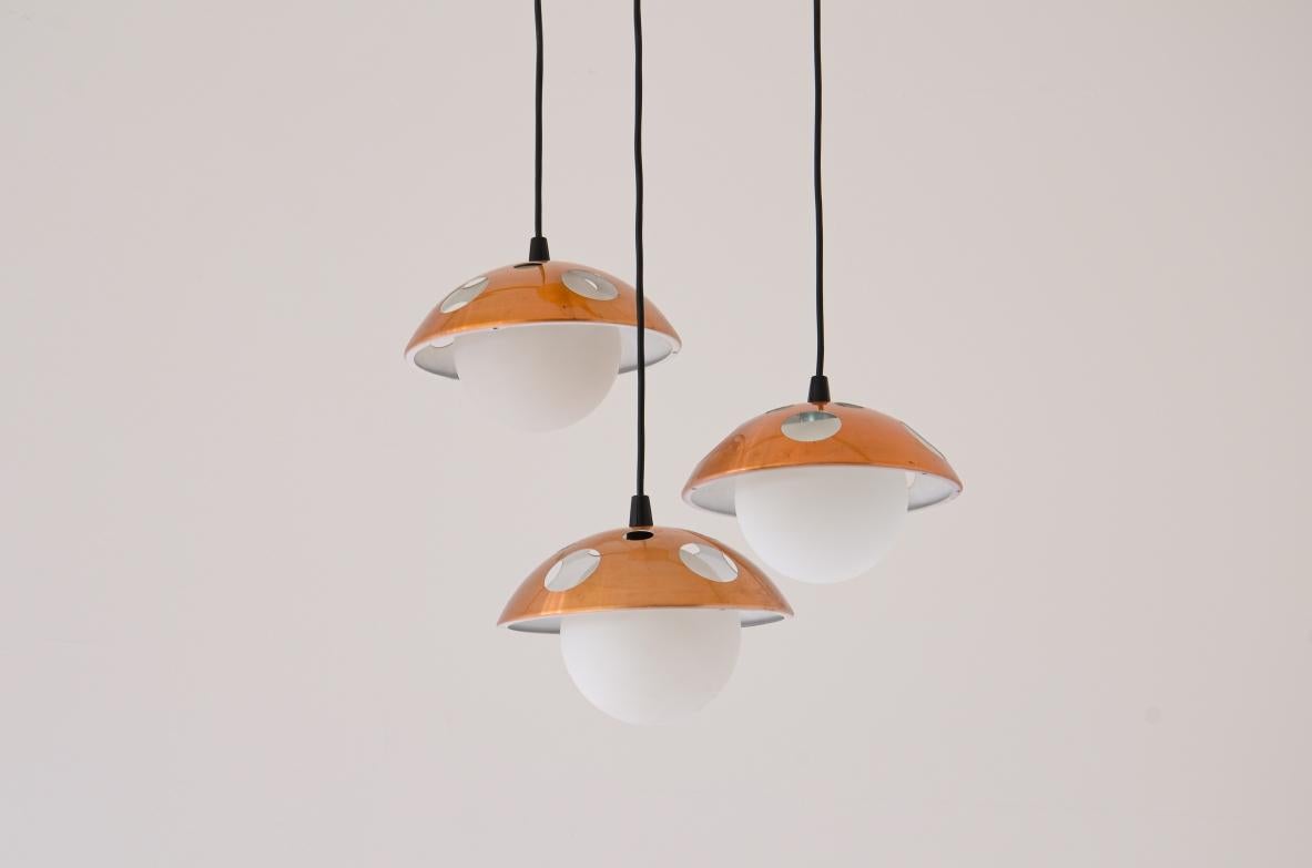 Mid-Century Modern 1960's Small three-light chandelier with perforated copper shades For Sale