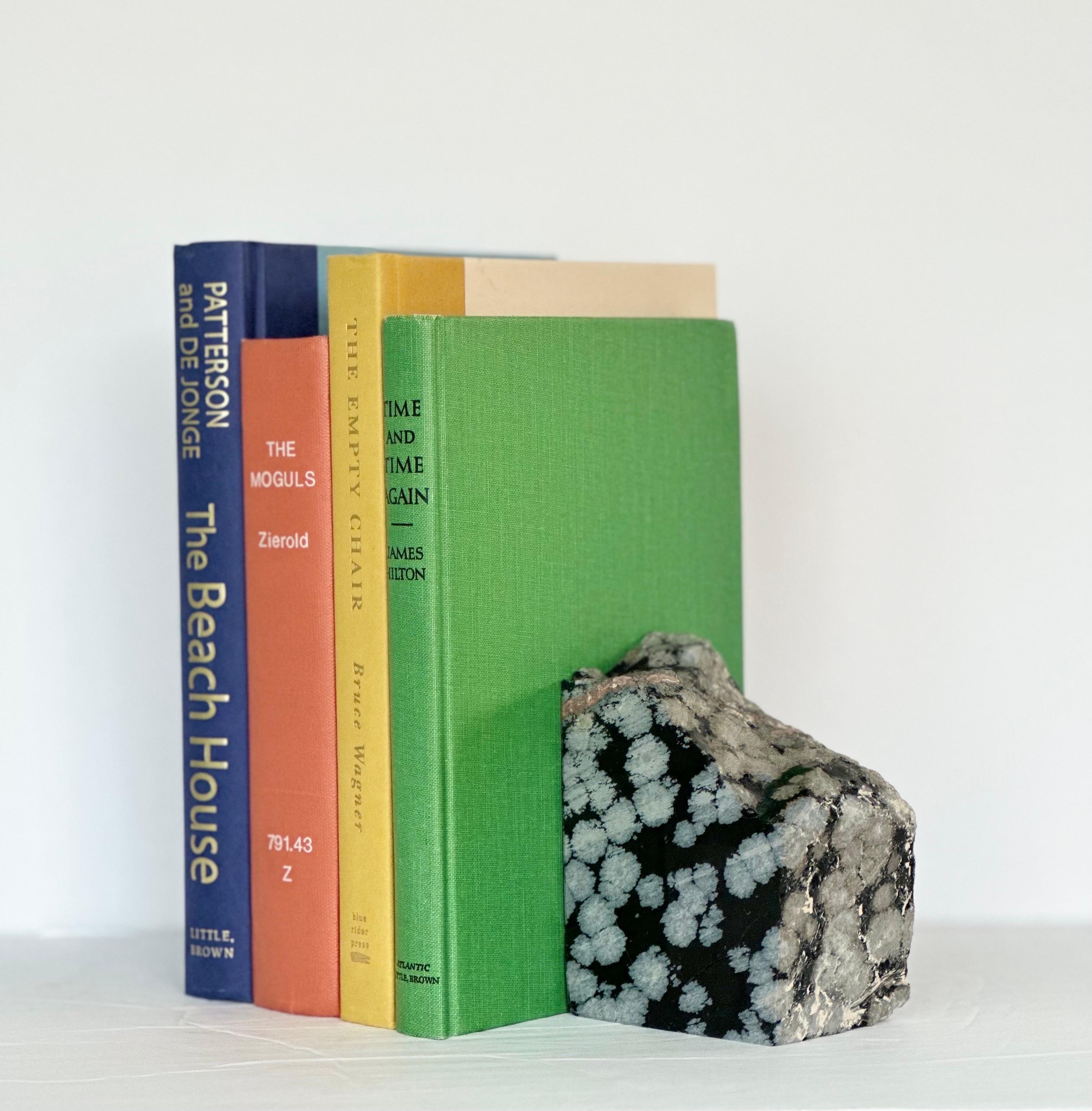 We are very pleased to offer a unique pair of bookends, circa the 1960s.  This set is made of snowflake obsidian, a type of volcanic glass that features grayish splotches resembling snowflakes, created by the inclusion of crystals.  The contrast