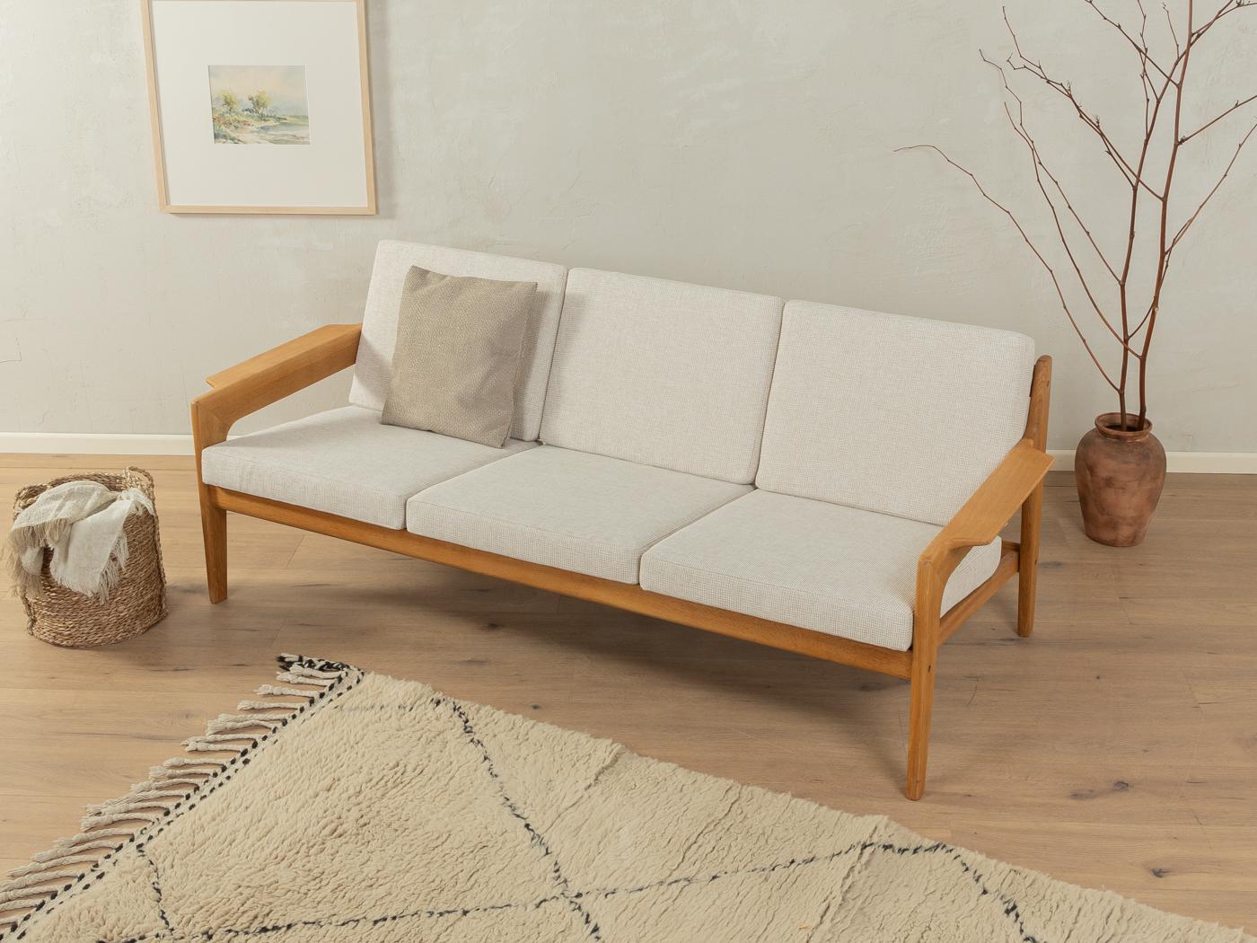 Classic 3-seater-sofa in oak from the 1960s by Arne Wahl Iversen for Komfort. The sofa has been reupholstered and covered with a high-quality fabric in beige.

Quality Features:
    accomplished design: perfect proportions and visible attention to
