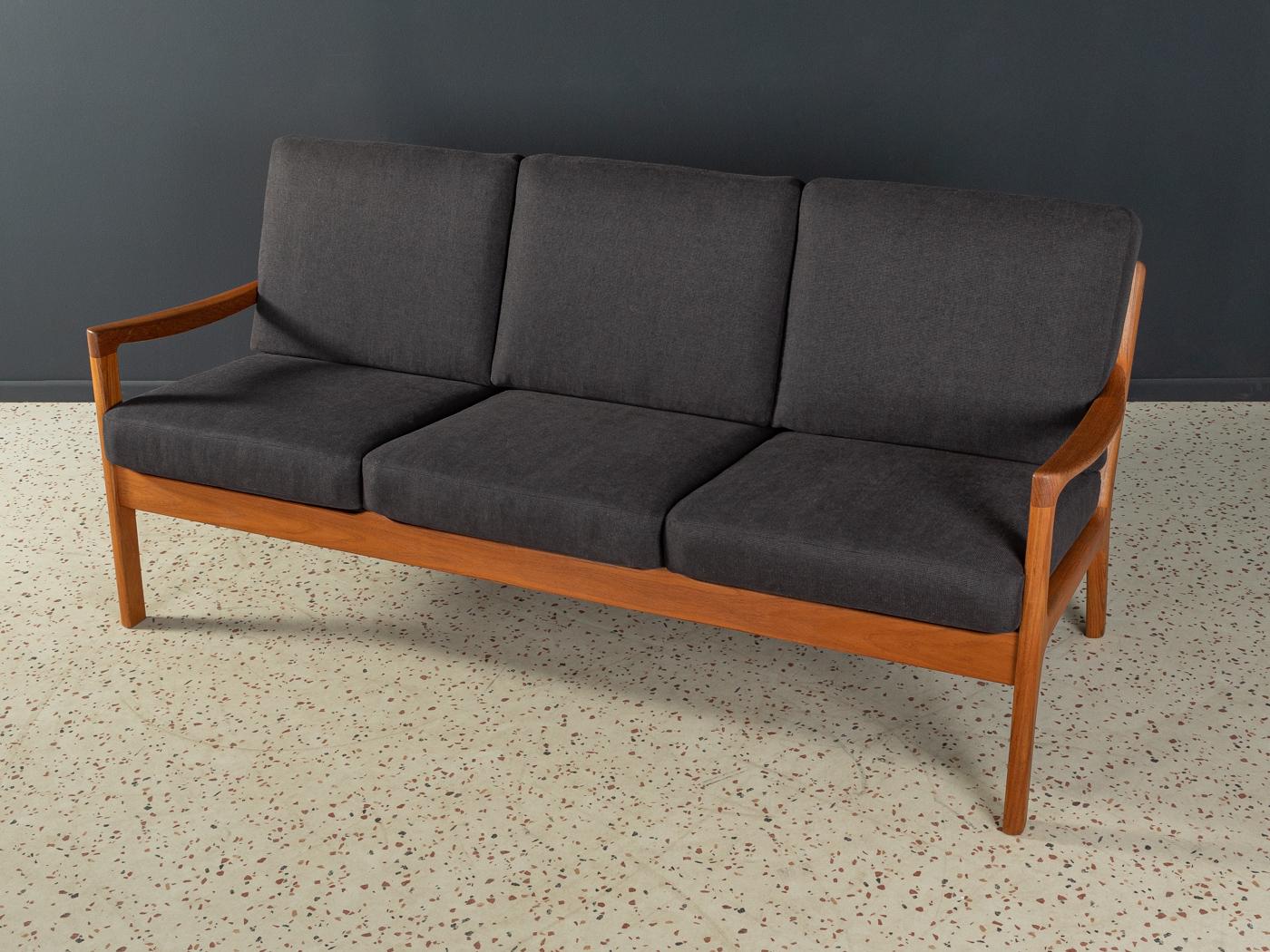 Classic 3-seater-sofa from the 1960s. Model Senator by Ole Wanscher for CADO. High-quality solid teak frame. The original spring core has been reupholstered and covered with a high-quality fabric in black.

Quality Features:
 accomplished design: