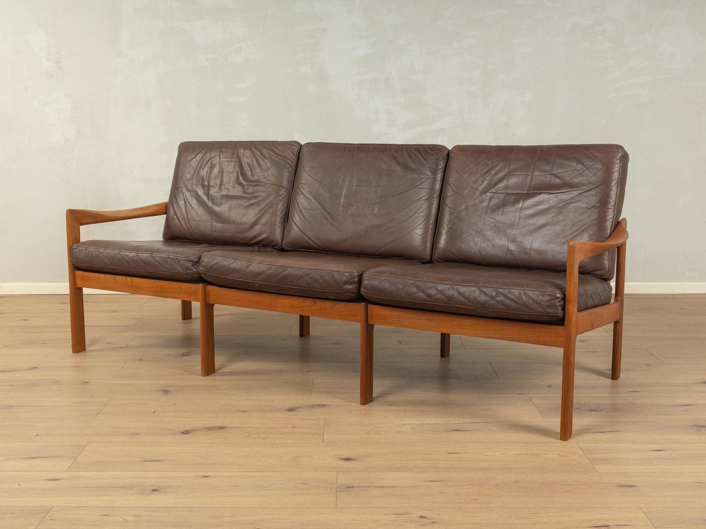 Classic sofa from the 1960s. High-quality frame made of solid teak with the high-quality original leather cover in brown.

Quality Features:

    accomplished design: perfect proportions and visible attention to detail
    high-quality workmanship