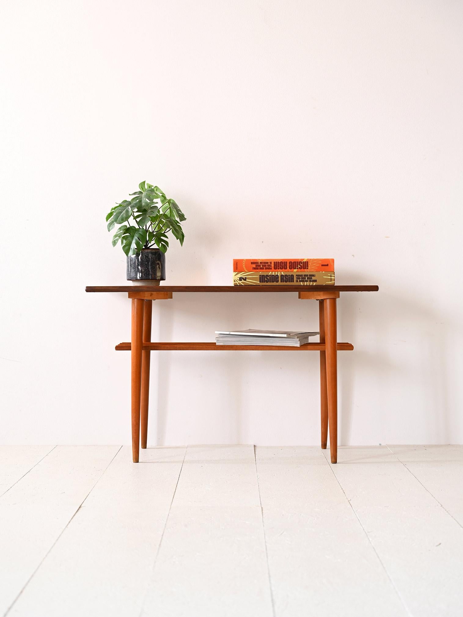 Vintage teak and birch coffee table.

The simple, minimalist lines of this modernist piece of furniture echo the Nordic tradition of combining aesthetics and functionality. Consisting of a large table top and long tapered legs, it also features a