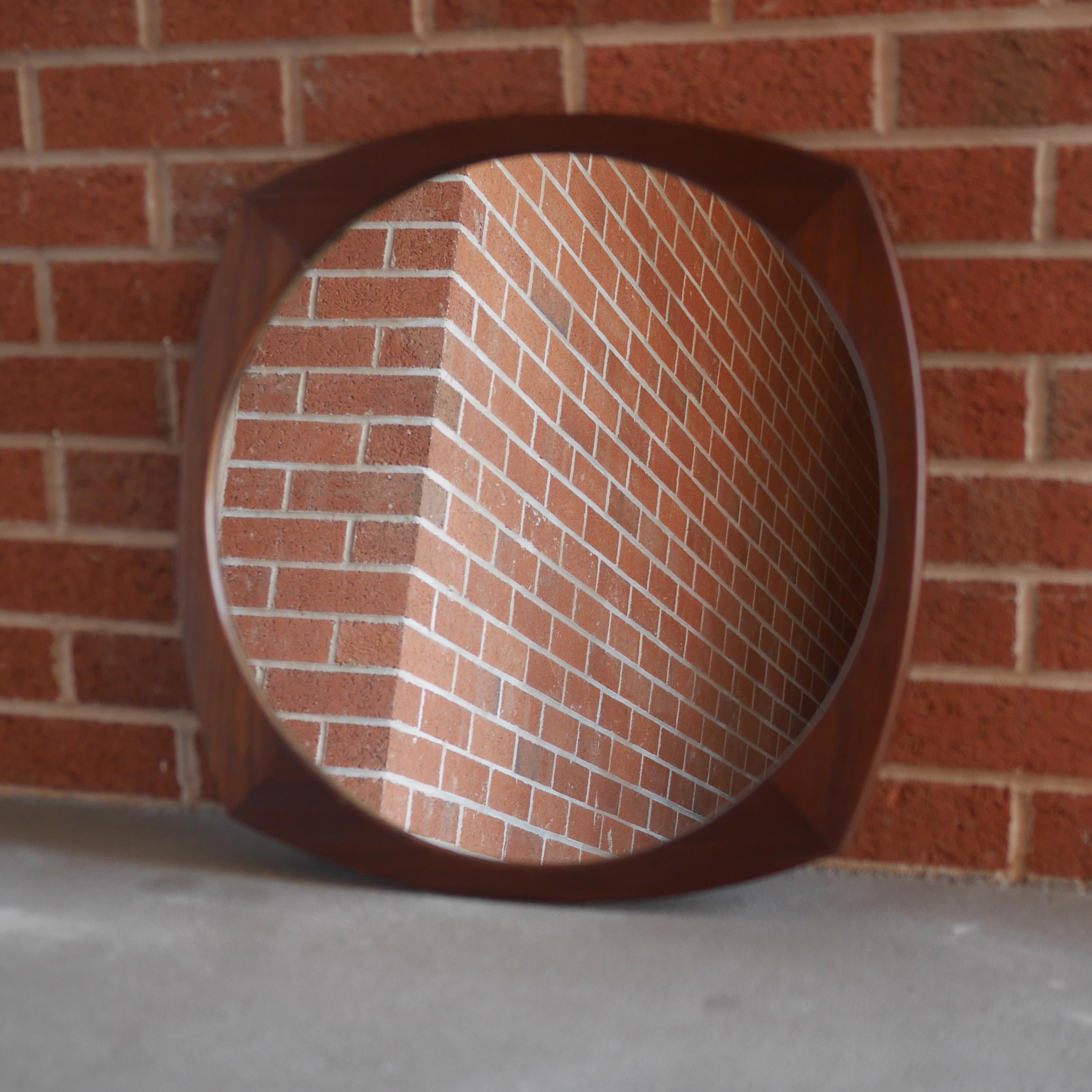 A lovely 1960s lozenge shaped frame constructed from solid afrormosia with a large (50cm diameter) recessed circular mirror in very good vintage condition with only very light foxing / spots and surface scratches commensurate with age. Most probably