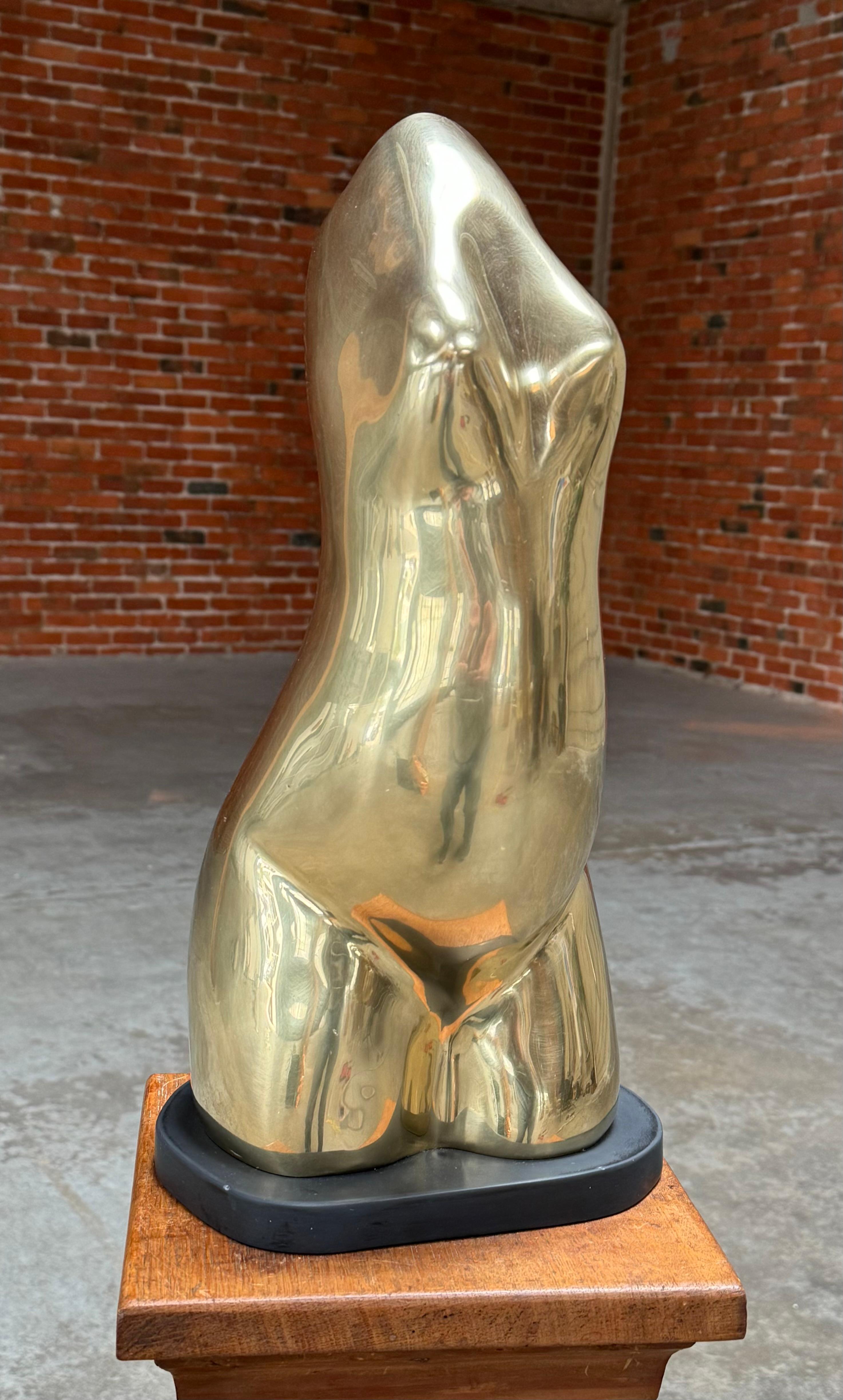 1960s New York artist John H Manhold figurative abstract brass sculpture resting on a black marble base, an substantial sculpture weighting in at 30 pounds. Manhold had a very colorful life, a writer of books, 6 text books on medicine, dentistry and