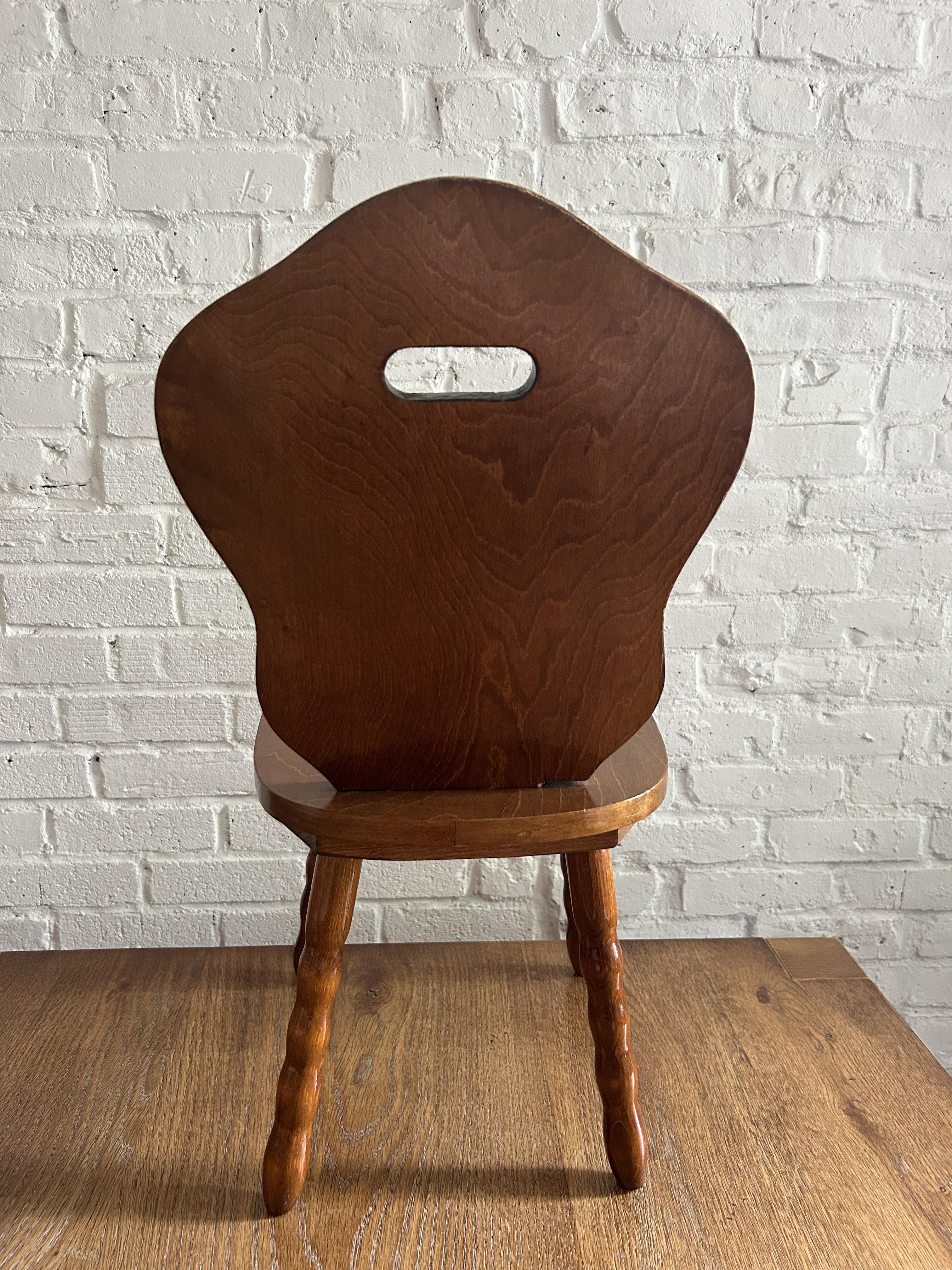 Adorable solid wood children's chairs. Features a carved solid back and seat atop four turned legs. While originally a children's chair, they would be best now as a decorative stool in a living room, entry way, bedroom or bathroom. The solid wood is