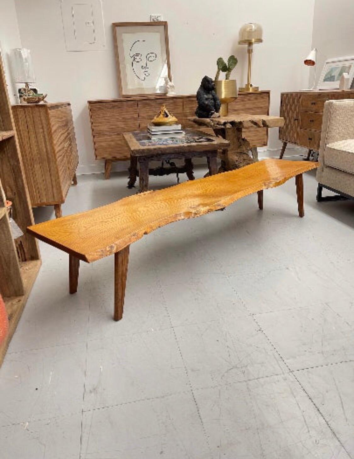 A functional solid wood slab bench imported from UK. This piece can be used as a plant stand or accessory bench or as a entry way stand. It measures 70W 14H 19D.