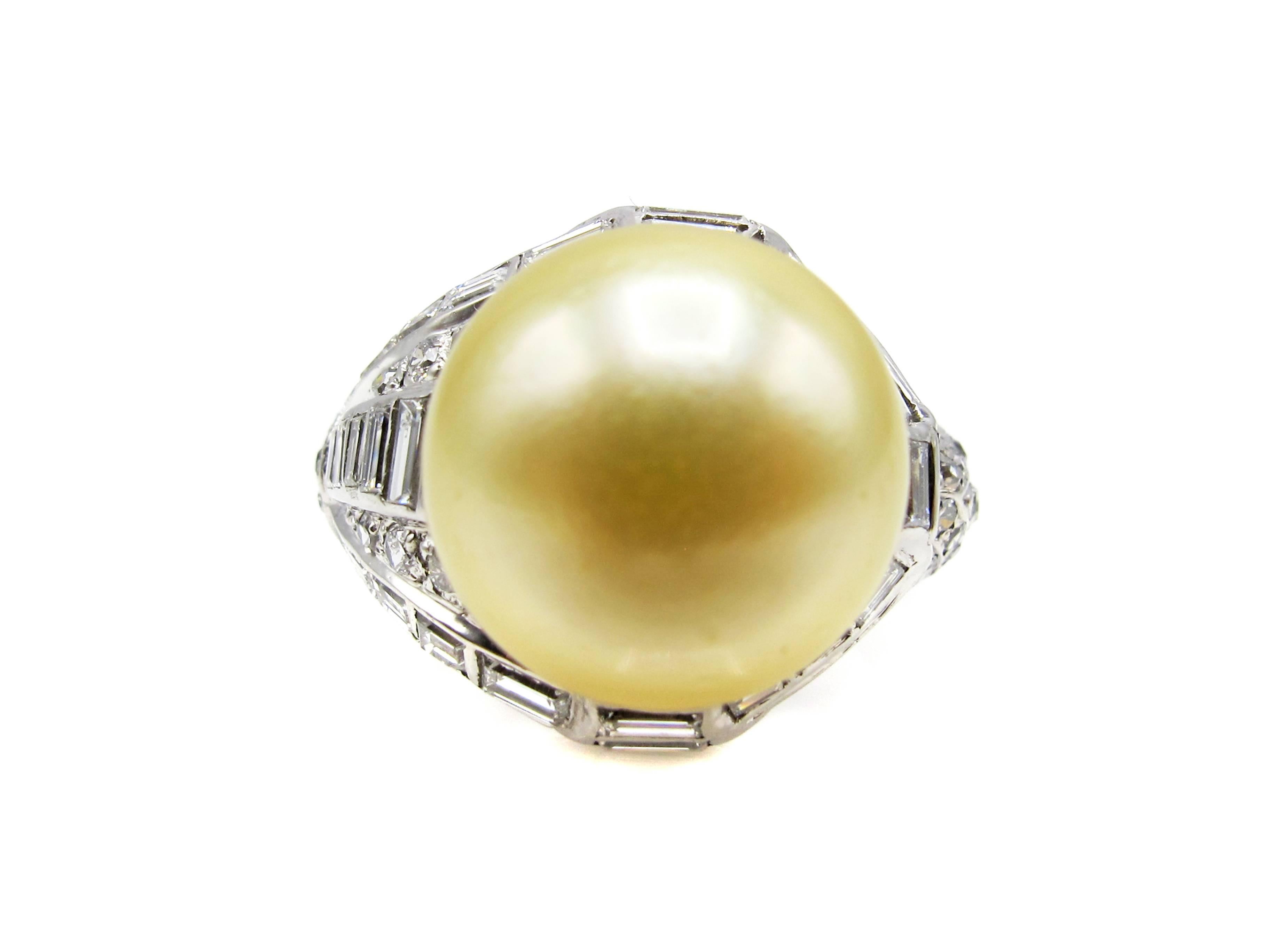 Unusual 1960s asymmetrical South Sea Pearl and diamond ring hand crafted out of 18 karat white gold. This gorgeous perfect slightly golden colored South Sea pearl measures approximately 13.20mm x 11.00 mm and has practically no blemishes with an