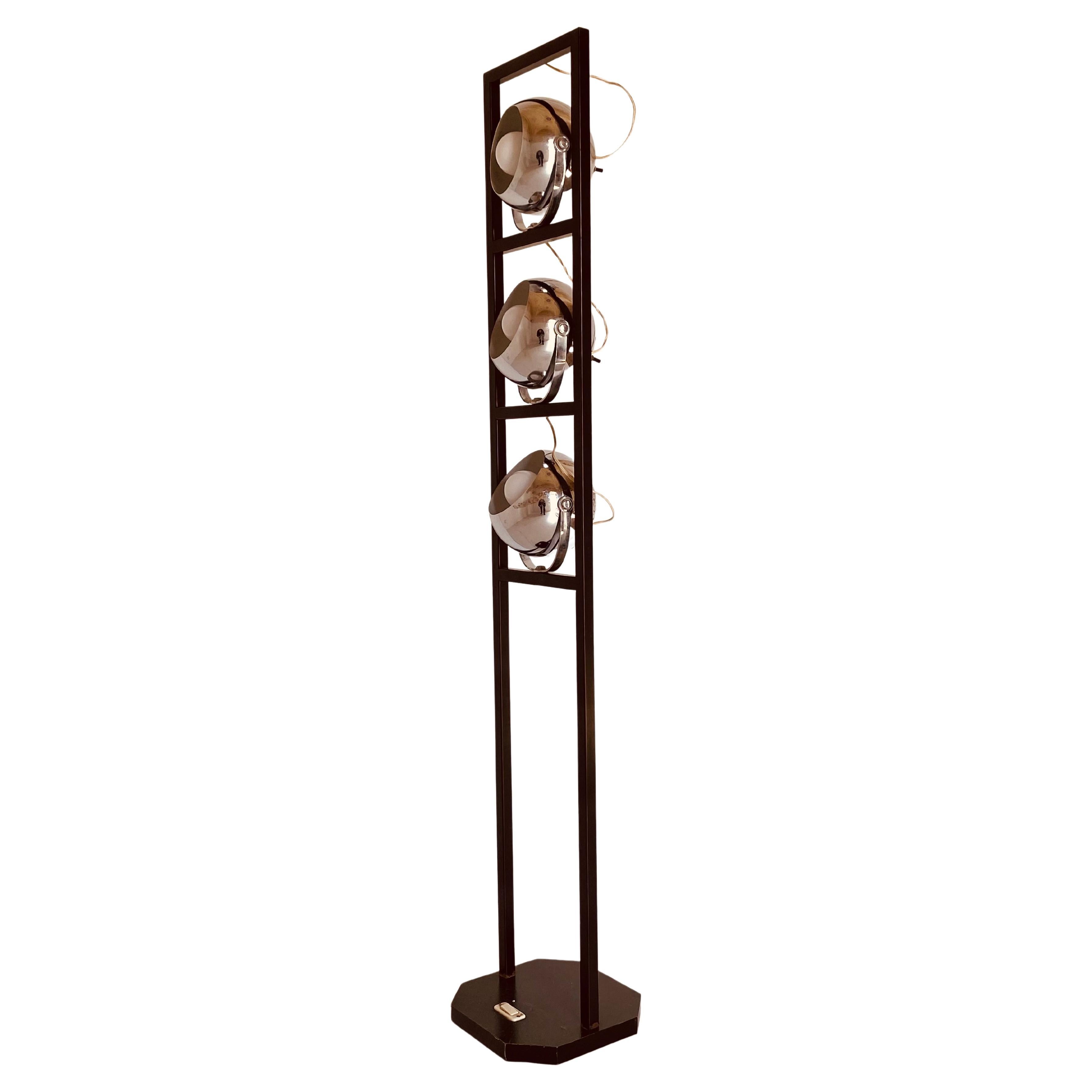 A 1960s vintage floor lamp manufactured in Italy in the 1960's.
Iron rectangular structure with three lights adjustable chromed spots. Each light spot can be switched on individually thanks to a switch on the back of the globe. The lamp has been