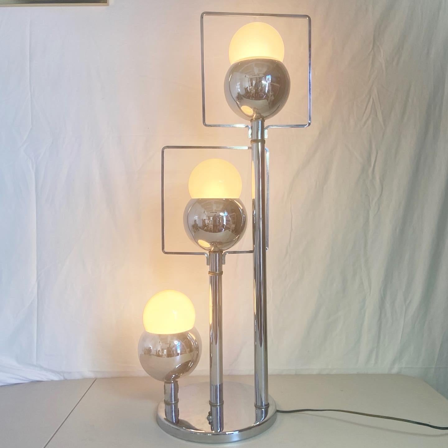 Amazing pair of space age mid century modern chrome table lamps. Each lamp features 3 accenting heads each with a square framing the bulb. Light bulbs are not included. less

